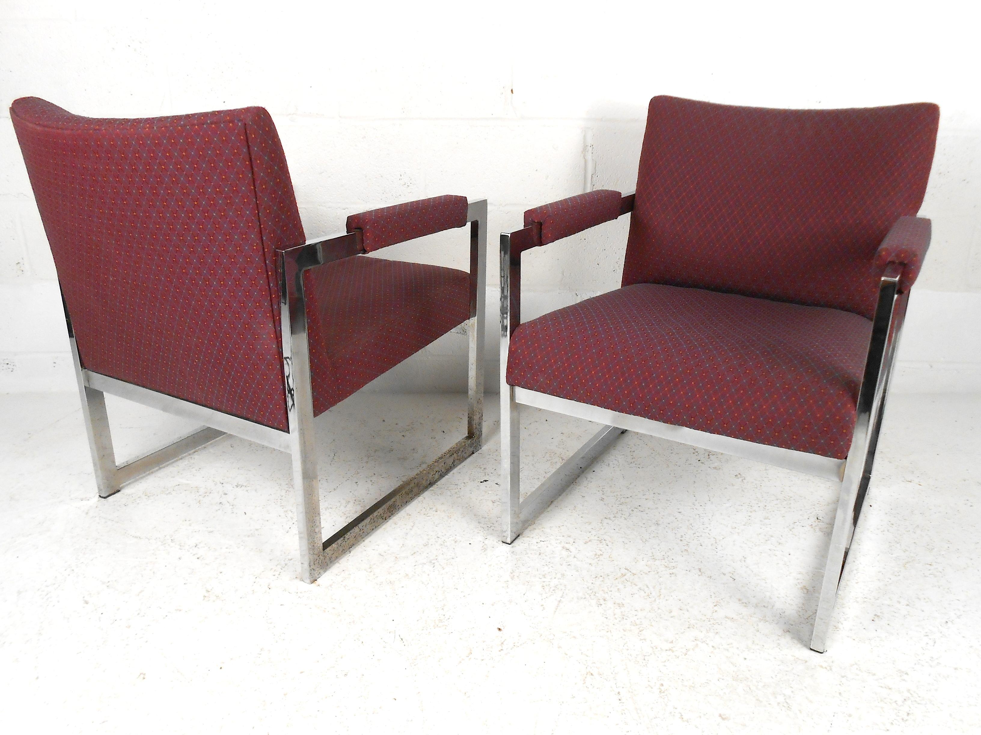 This pair of sturdy midcentury lounge chairs feature lush upholstery and an eye-catching chrome support frame. With a simple yet elegant style, this set will accent any space it is placed in. Perfect for your family room or home library. Please