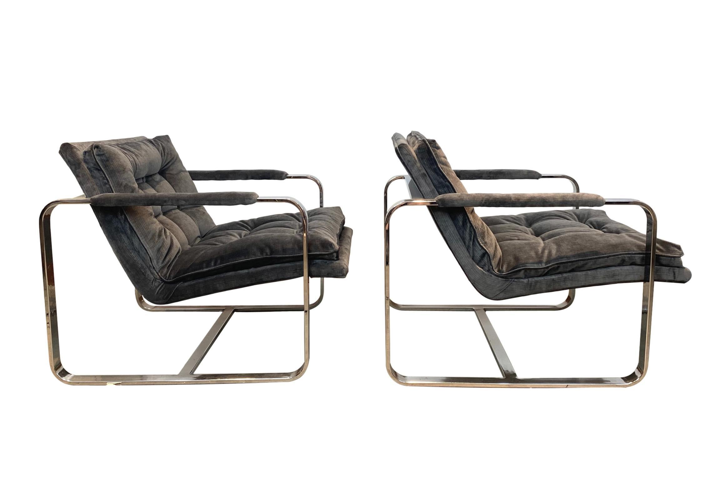 Pair of Mid-Century Modern chrome frame lounge chairs, circa 1970, newly upholstered in silver or grey shiney Scalamandré Paddington Striae velvet, 100% cotton (sku 04167604, pattern 36168).