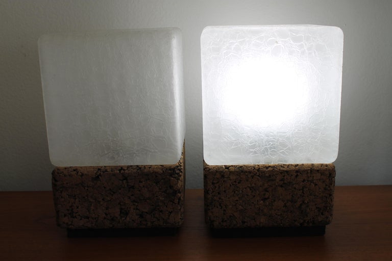 A matched pair of cork lamps with frosted and textured glass cube shades. Lamps have been professionally rewired with on/off switches. Each lamp measures 8
