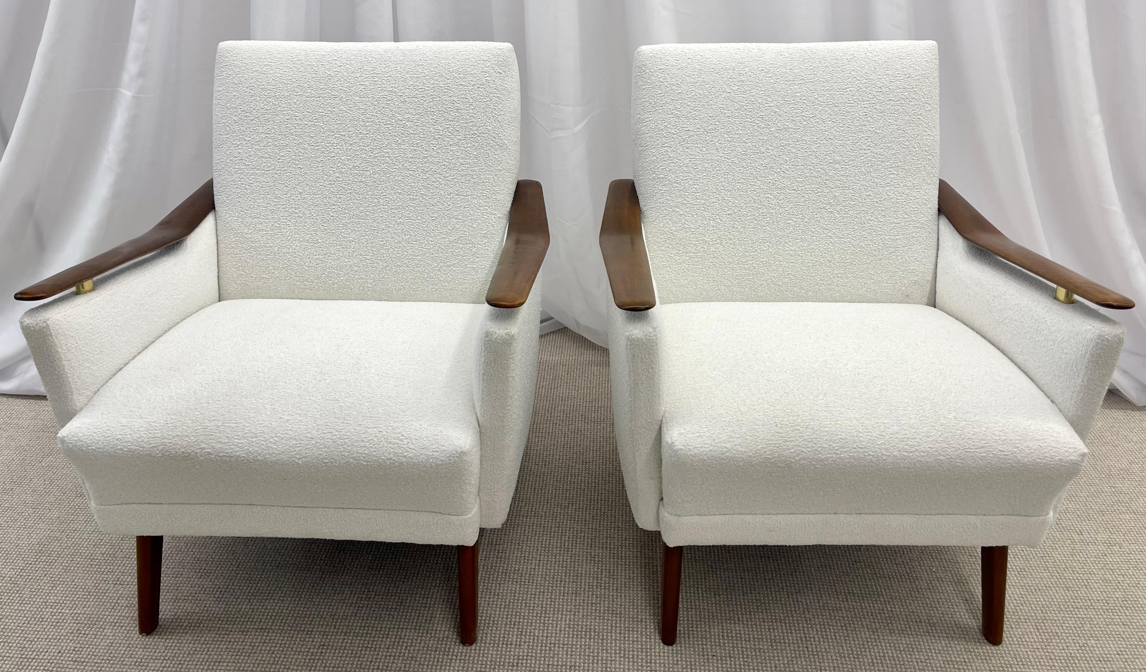 Pair of Mid-Century Danish lounge chairs, Manner of Finn Juhl, Bouclé, 1970s.
Newly Upholstered in white bouclé this finely crafted pair of mahogany floating arm chairs have brass supports under each arm. The pair having been recently reupholstered