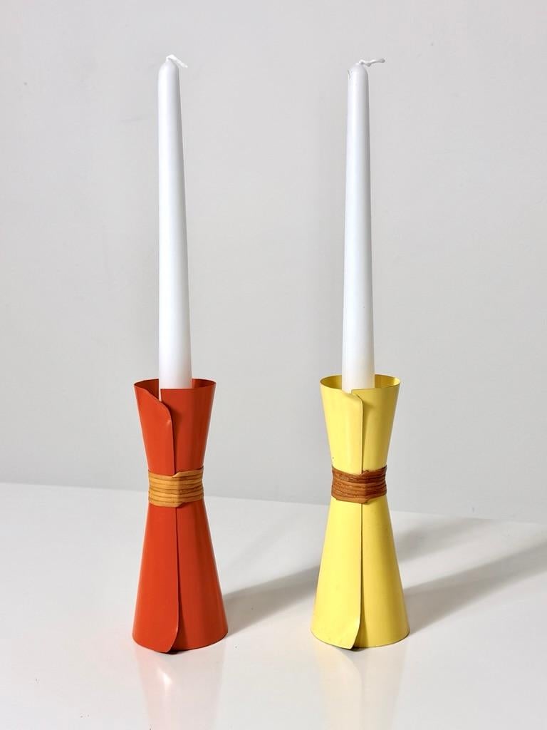 Rare enamel and rattan candlestick holders by Laurids Lonborg
Denmark 1960s

Red and yellow enameled steel folded into an hourglass form with rattan wrapped center
Yellow candle holder retains original label

2.5 inch diameter
6.5 inch height