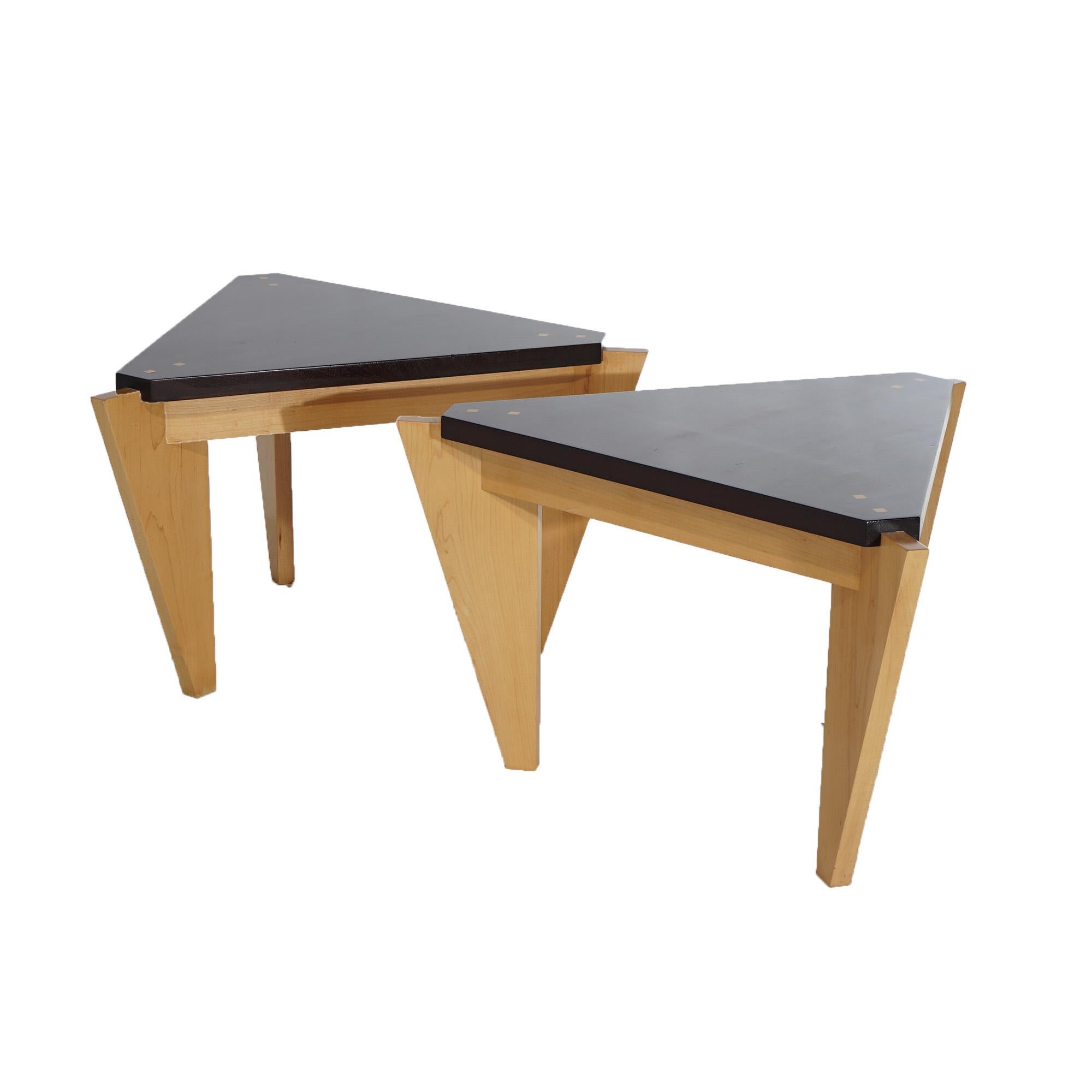 A pair of Mid Century Danish Modern side stands offer maple construction in stylized triangular form and having mahogany tops raised on tapered geometric legs, 20th century

Measures- 17.75''H x 30.5''W x 26''D