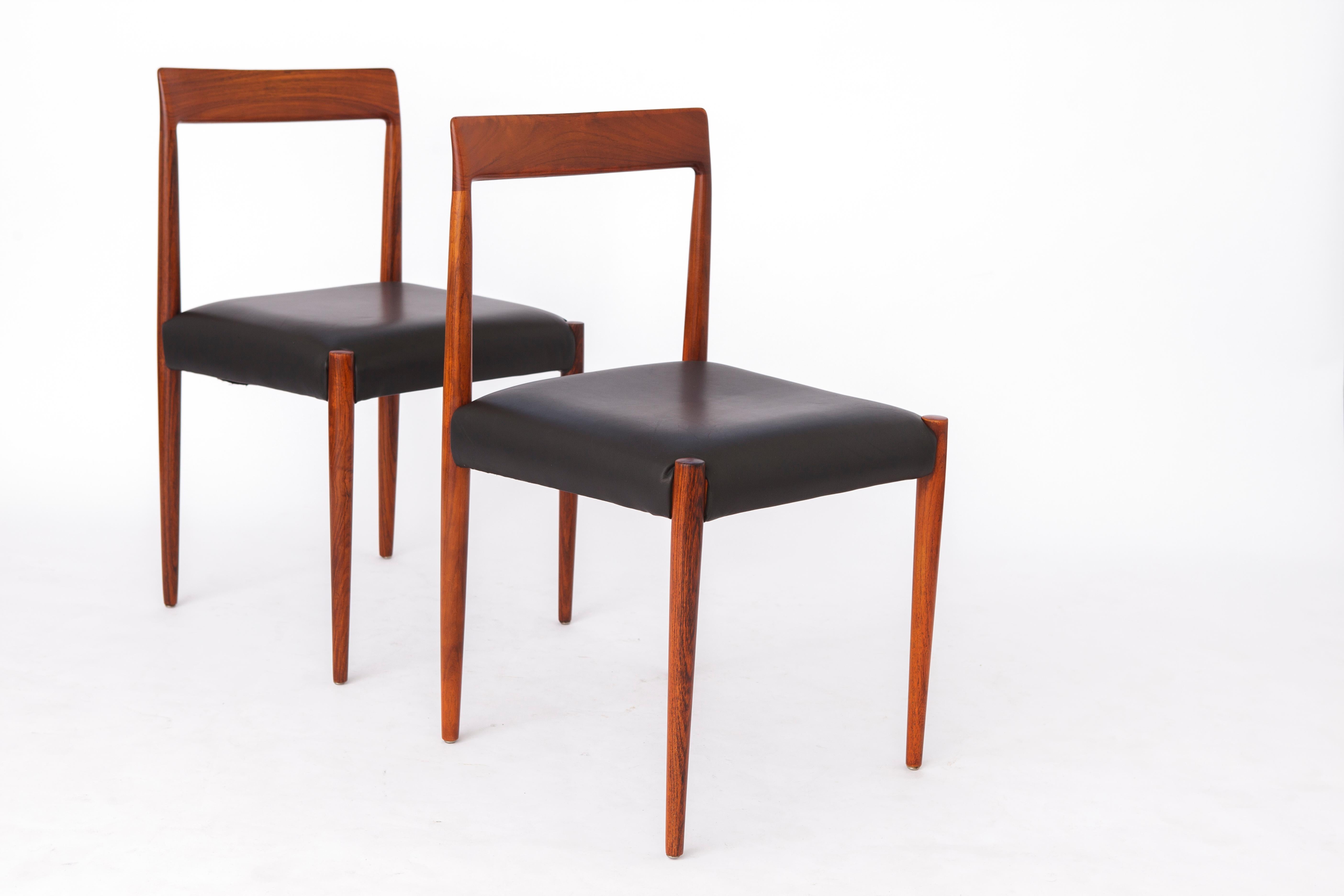 Two vintage dining chairs by manufacturer Lübke, Germany. 
Production period: 1960s. 
Displayed price is for a pair. 

Very good condition. Stable teak wood frame. Refurbished and oiled. 
Original black leather cover in very good condition. Treated