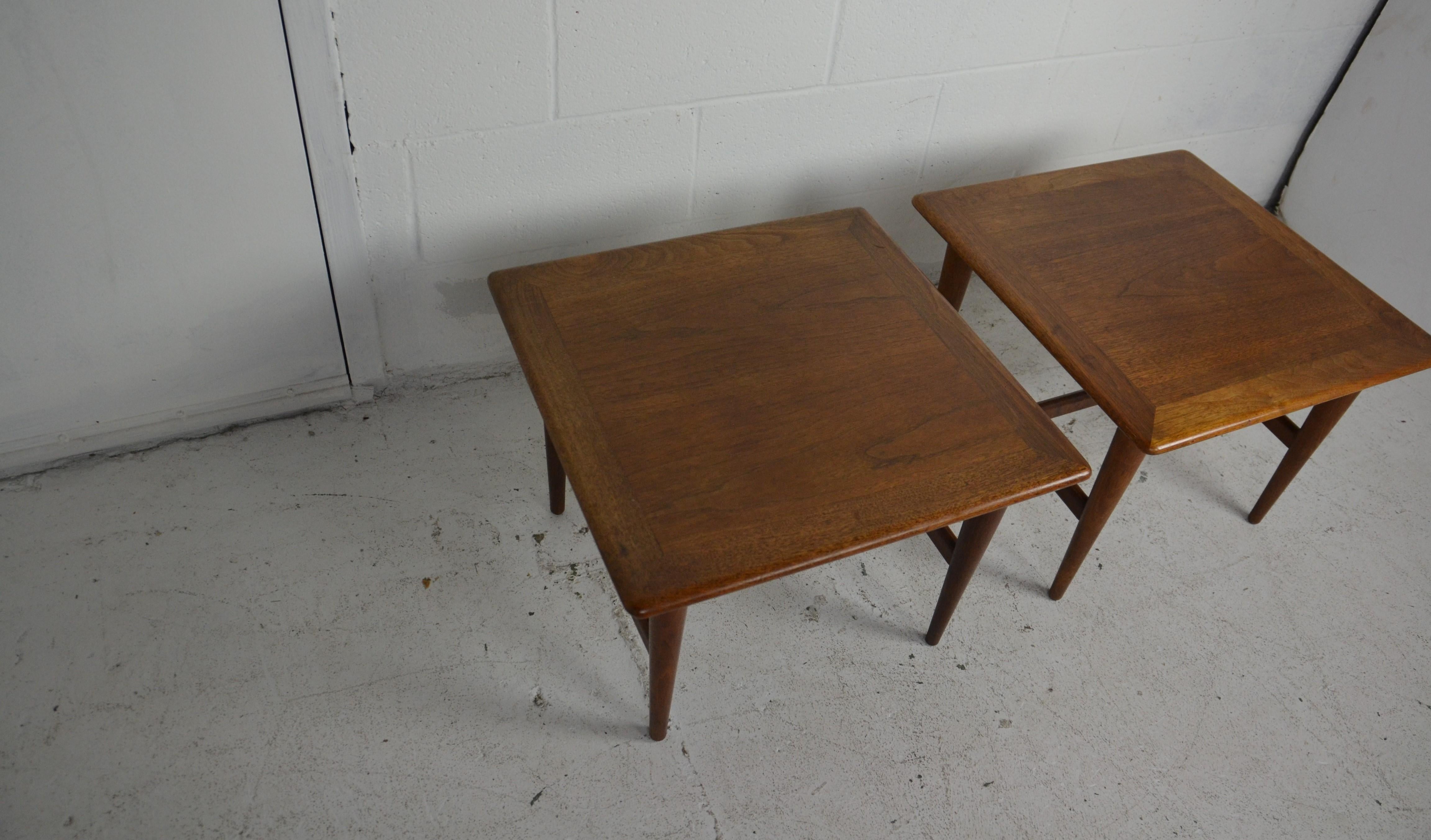 A pair of small size midcentury end tables in teak wood. Tapered legs with 