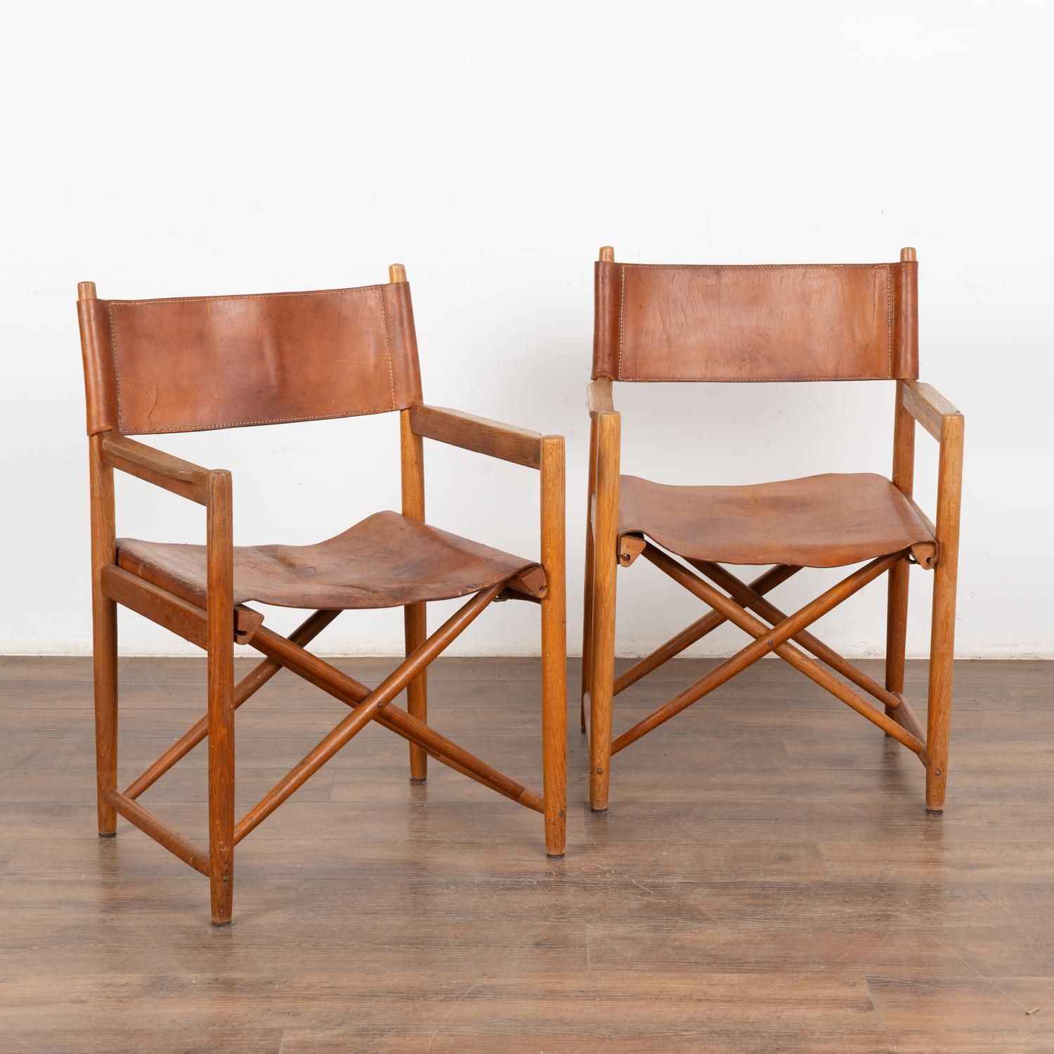 Pair of Mid Century Modern brown leather folding chairs from Denmark.
Simple brown leather seat and back on hard wood frame create a timeless look with simple clean lines.
Sold in vintage used condition, leather shows typical age-related wear with