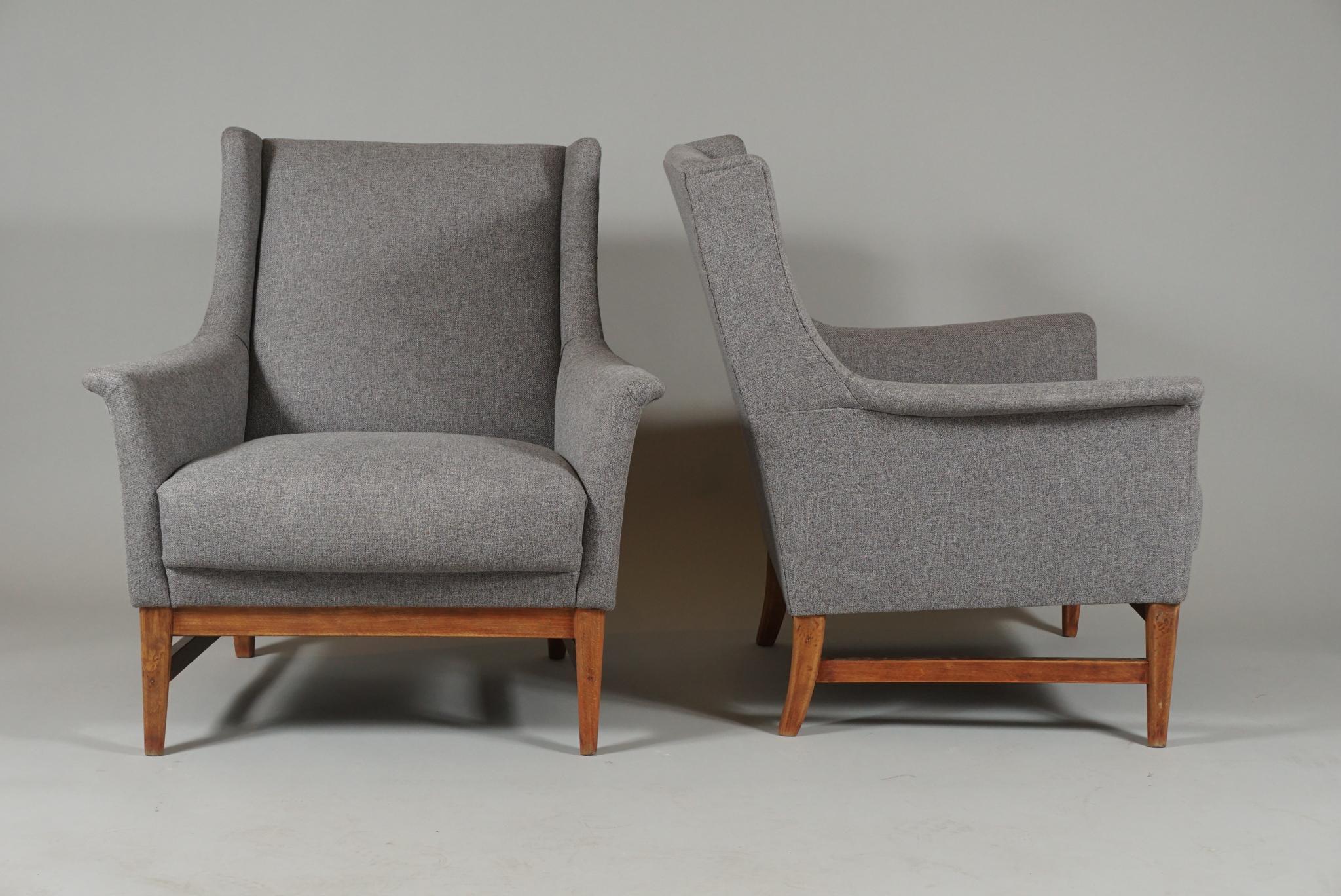 Beautifully upholstered midcentury armchairs. Interesting and unusual silhouette.