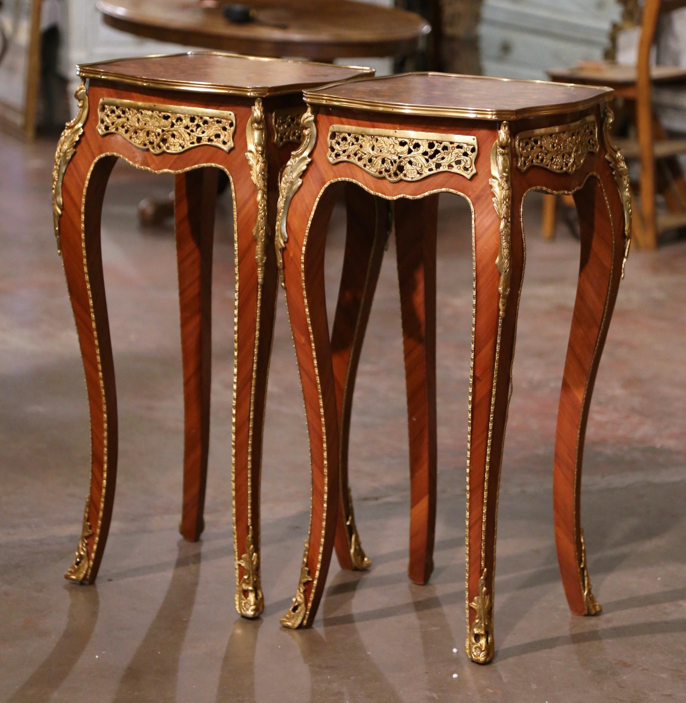 Decorate a living room or den with this elegant pair of antique side tables. Crafted in France, circa 1970 and square in shape with bombe sides, each table stands on cabriole legs embellished with bronze dore acanthus leaves mounts at the shoulder,