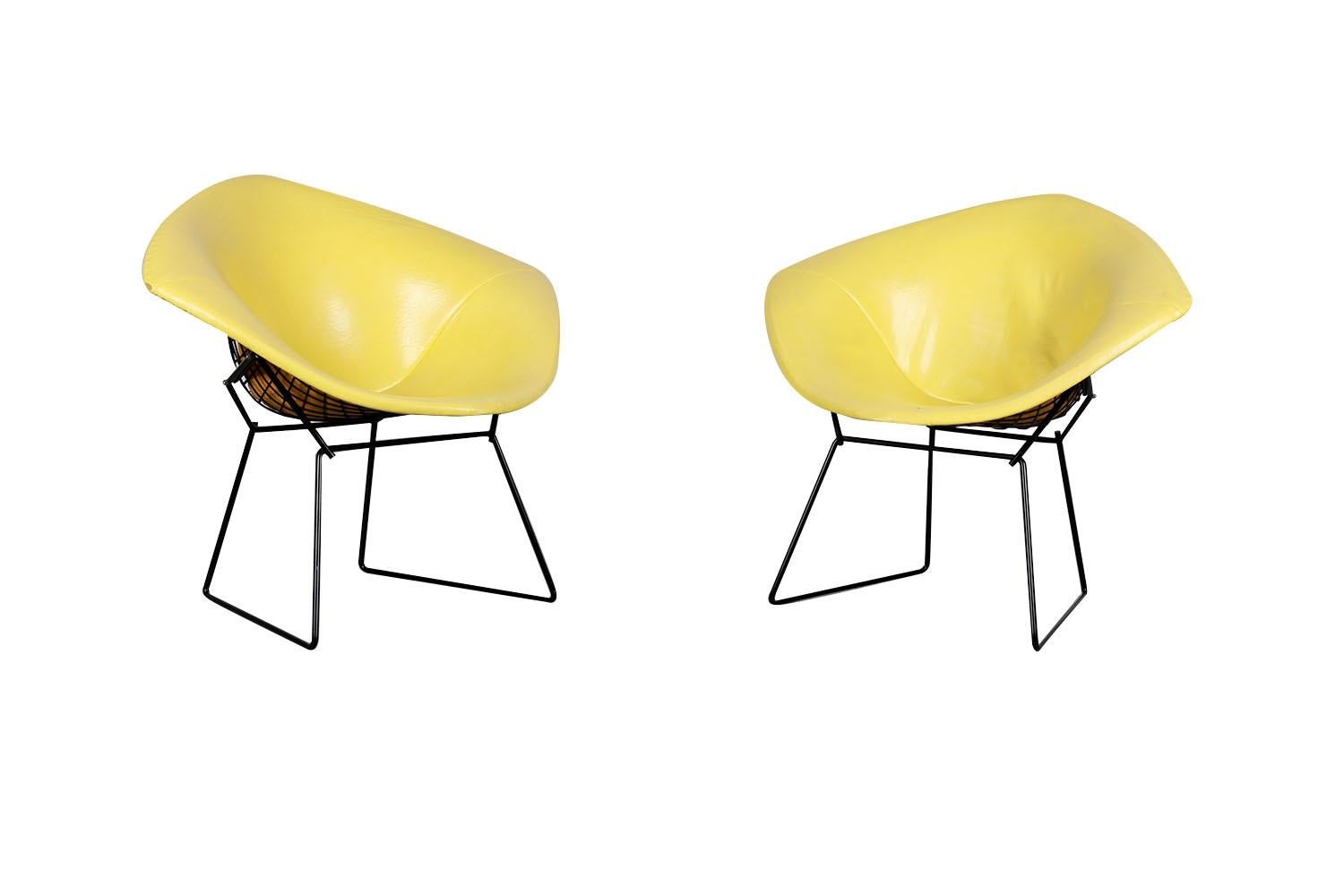 A beautiful pair of vintage, knoll, metal mid century, Harry Bertoia, Diamond Chairs. Nice early Harry Bertoia Diamond Chairs for Knoll. A vintage iconic pair designed by Harry Bertoia manufactured by Knoll features original yellow, removable,