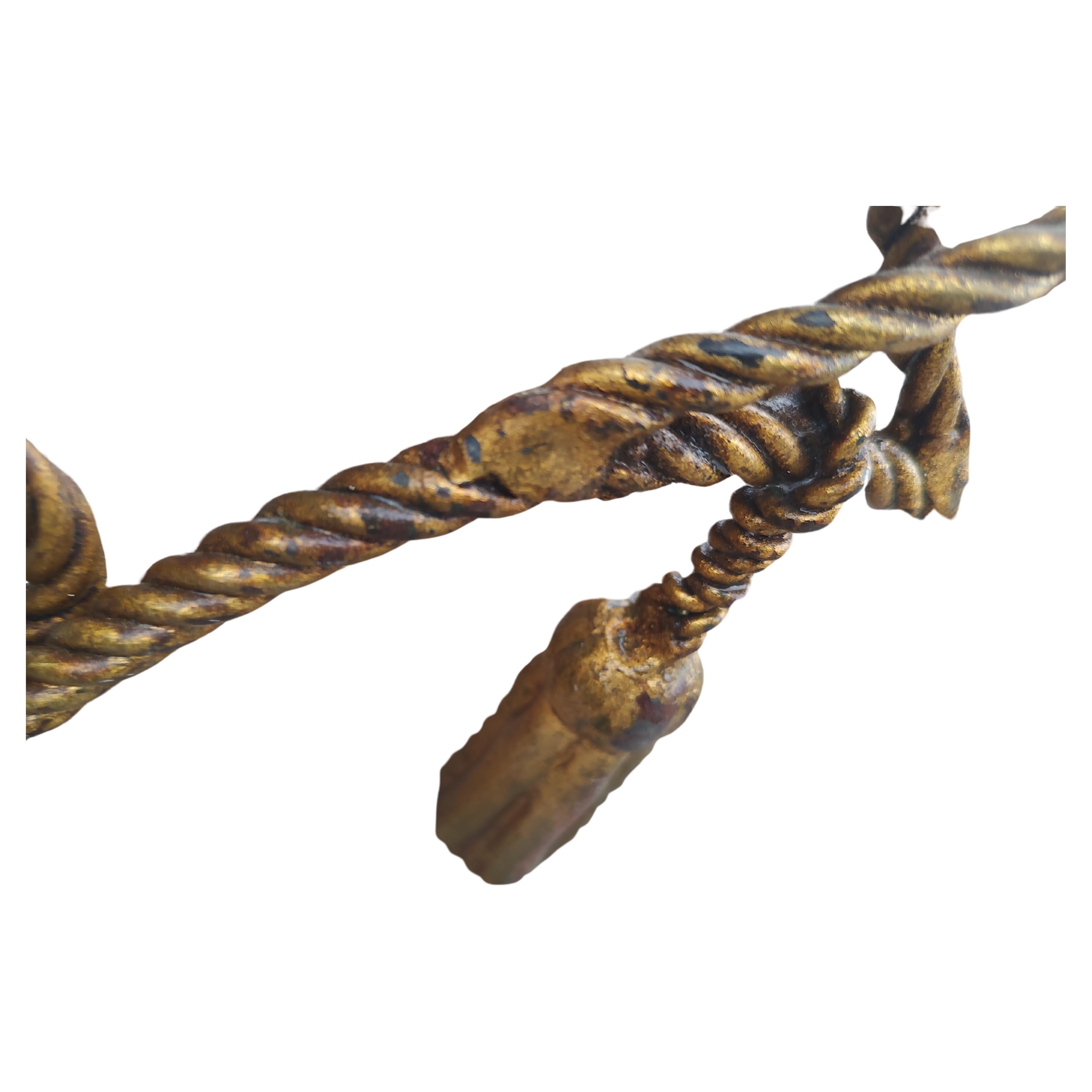 Fabulous pair of Gilt iron rope with tassels magazine racks holder from the mid fifties Italy. In excellent vintage condition with minimal wear to the Gilt. Some Gilt loss due to age related wear. One is a little darker than the other. Both