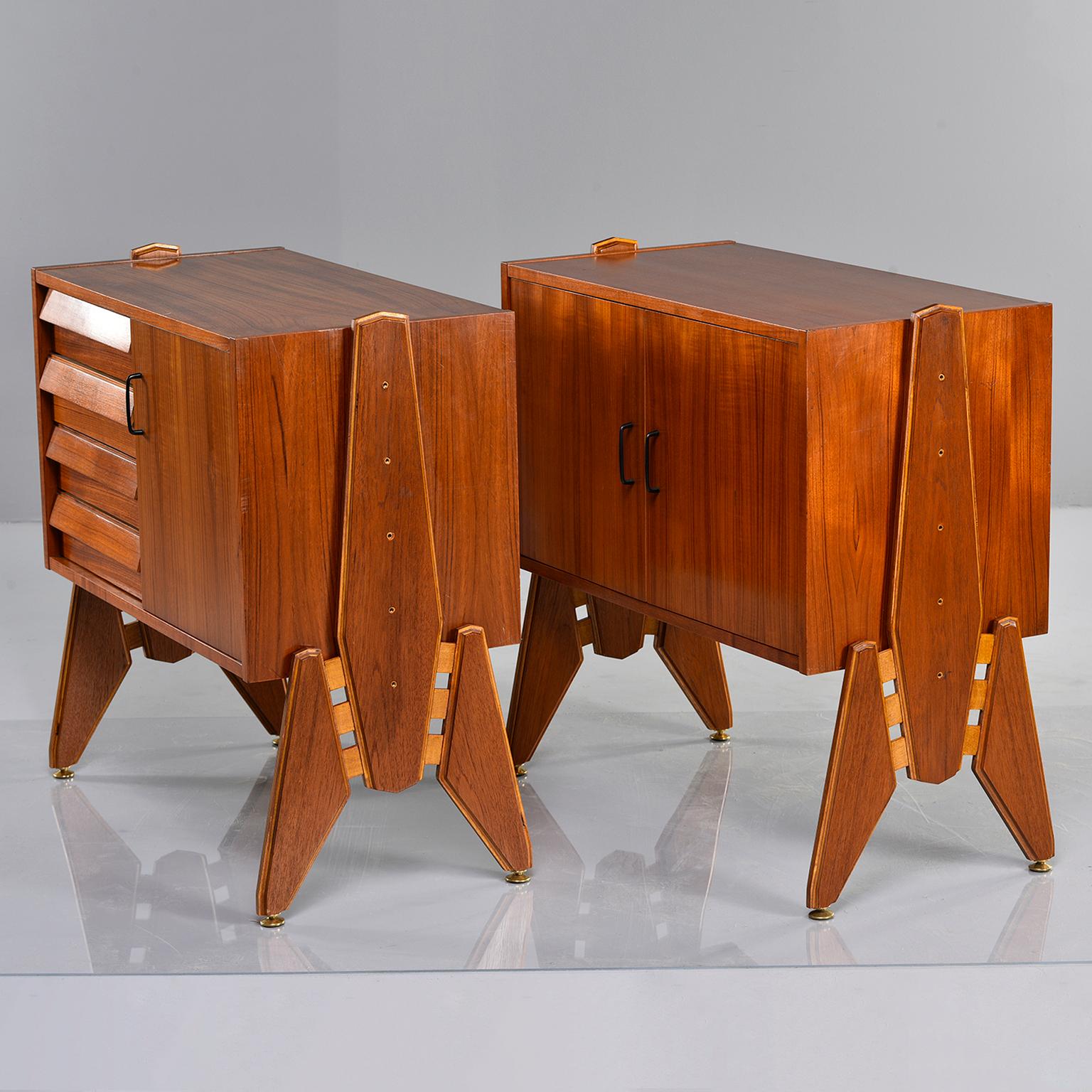 Pair of Italian teak side cabinets have interesting side mounted legs/supports that allow for height range between 31.5” and 27.5” Measurements shown are for cabinets as shown in photos, at their highest setting. One cabinet has four functional