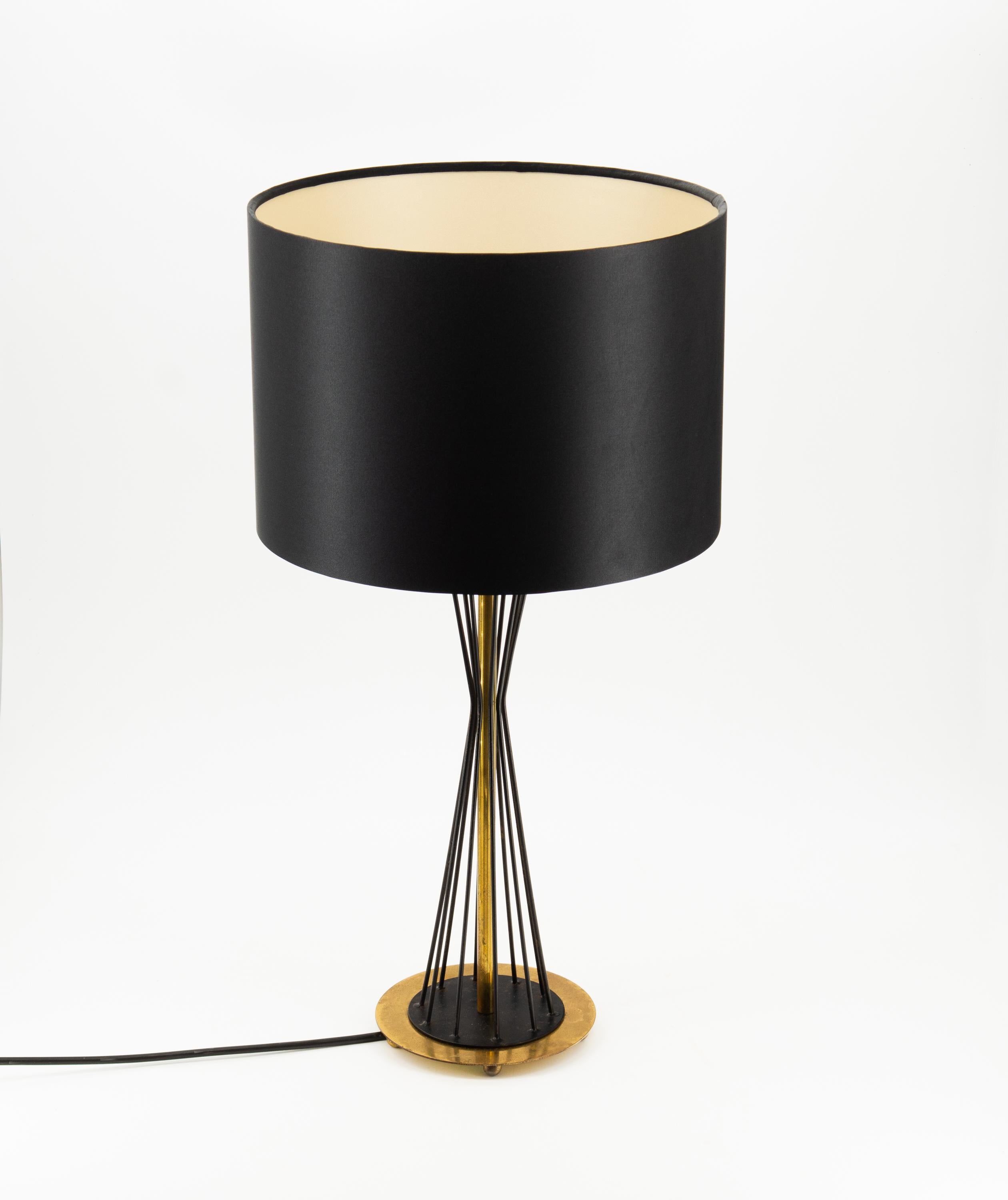 Pair mid century black & brass diablo table lamps. Italian. Circa 1950.

Delivery included to the UK.

The lamp bases have a diablo shaped black metal column with brass circular bases on four ball feet. They are in original untouched condition,