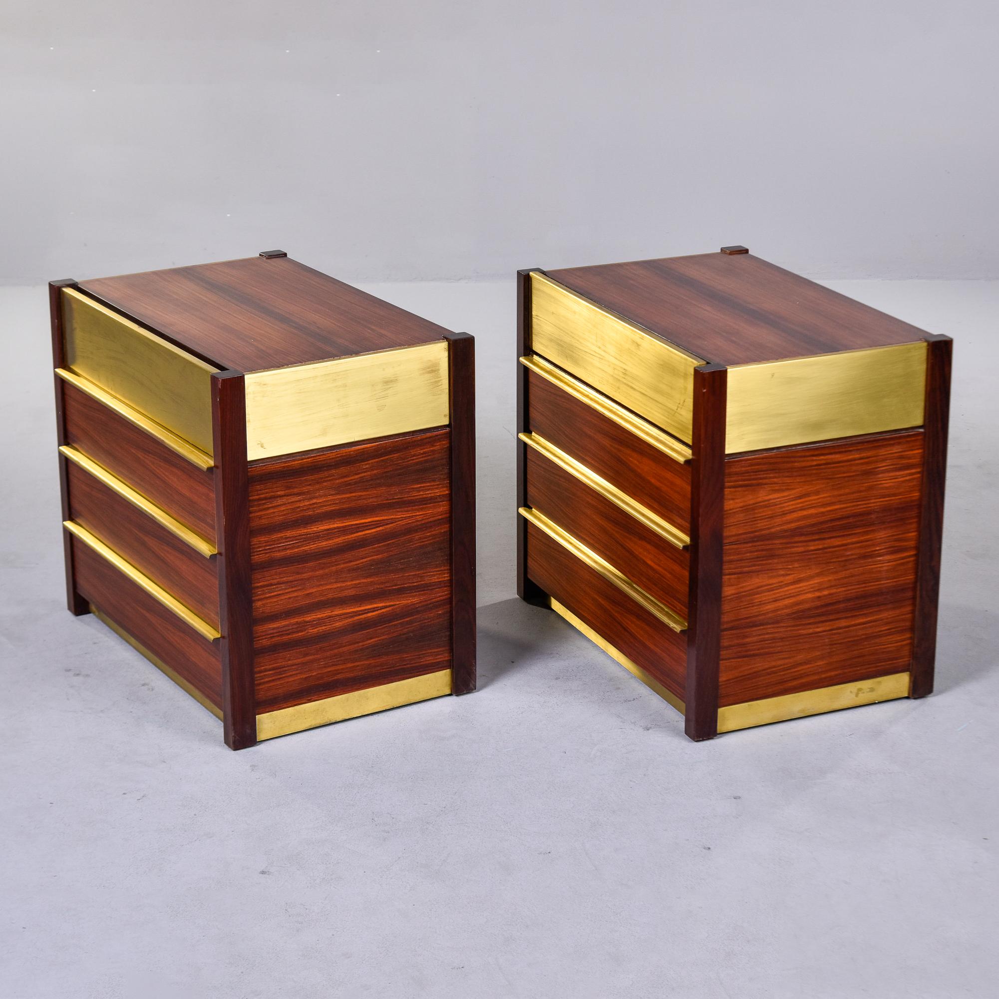 Found in Italy, this pair of brass and rosewood chests date from the 1970s. Each chest has four functional drawers with dovetail construction and brass pulls. Top drawer has brass front and there are brass accents on the sides at the base and tops.
