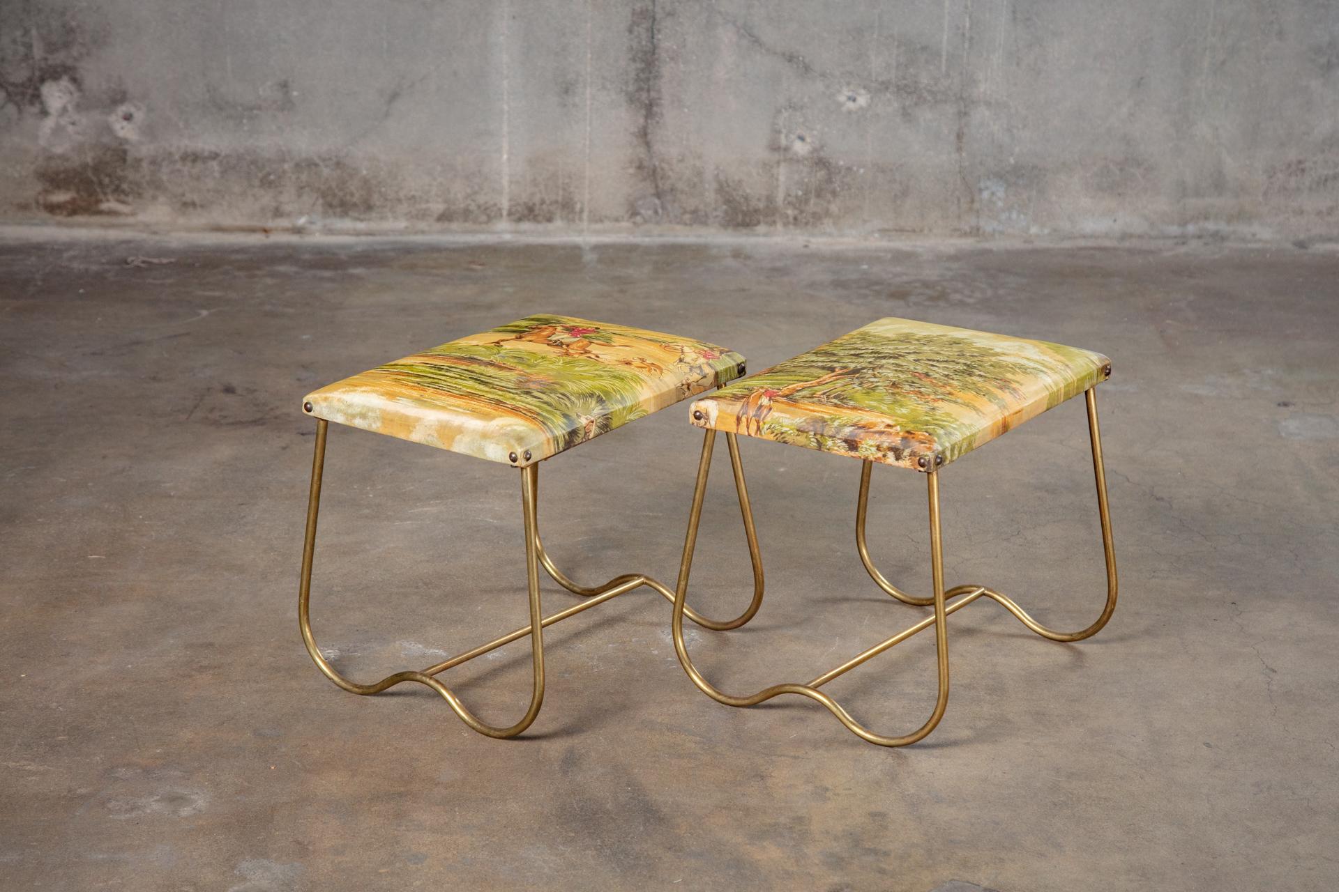 A pair of Italian midcentury brass benches or stools, with upholstered seats and shaped bases, circa 1950.