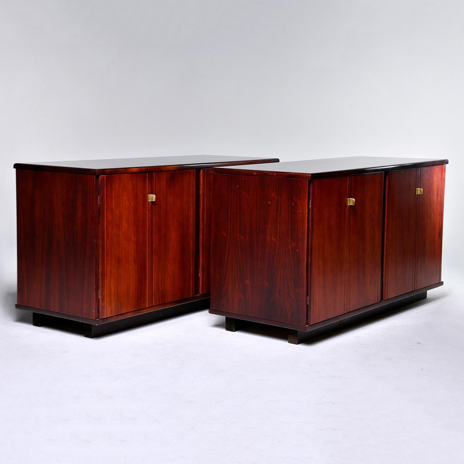 Pair of circa 1960s Italian rosewood cabinets. Each cabinet features two storage compartments with a single interior shelf and hinged doors with streamlined brass hardware. Unknown maker. Sold and priced as a pair.
 