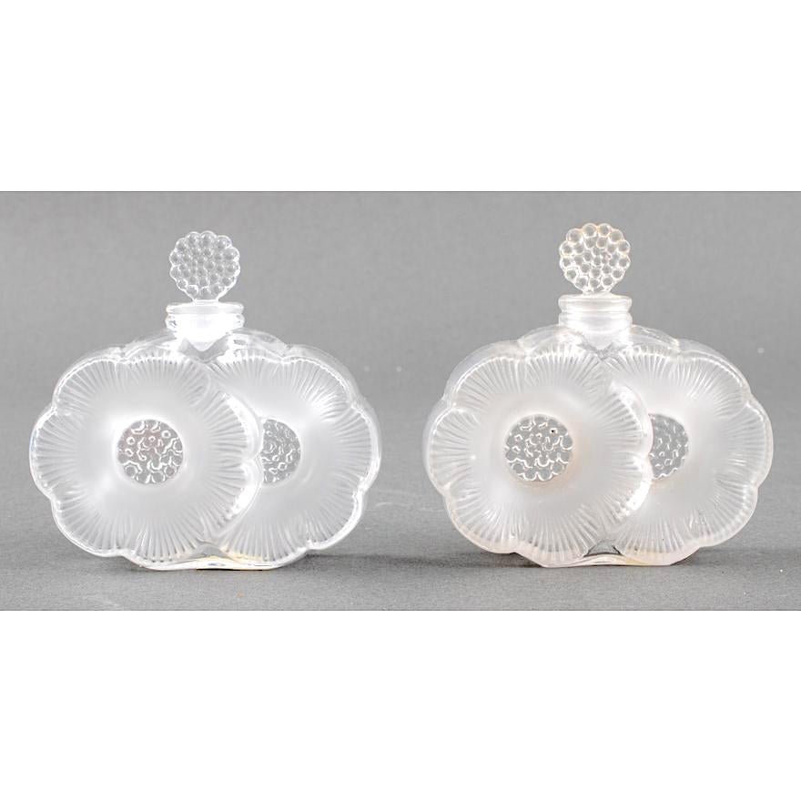 
Embark on a journey of timeless elegance with this exquisite pair of Mid-Century Lalique Crystal Perfume Bottles. Crafted with unparalleled artistry, each bottle is a testament to Lalique's legacy of creating enduring masterpieces in crystal