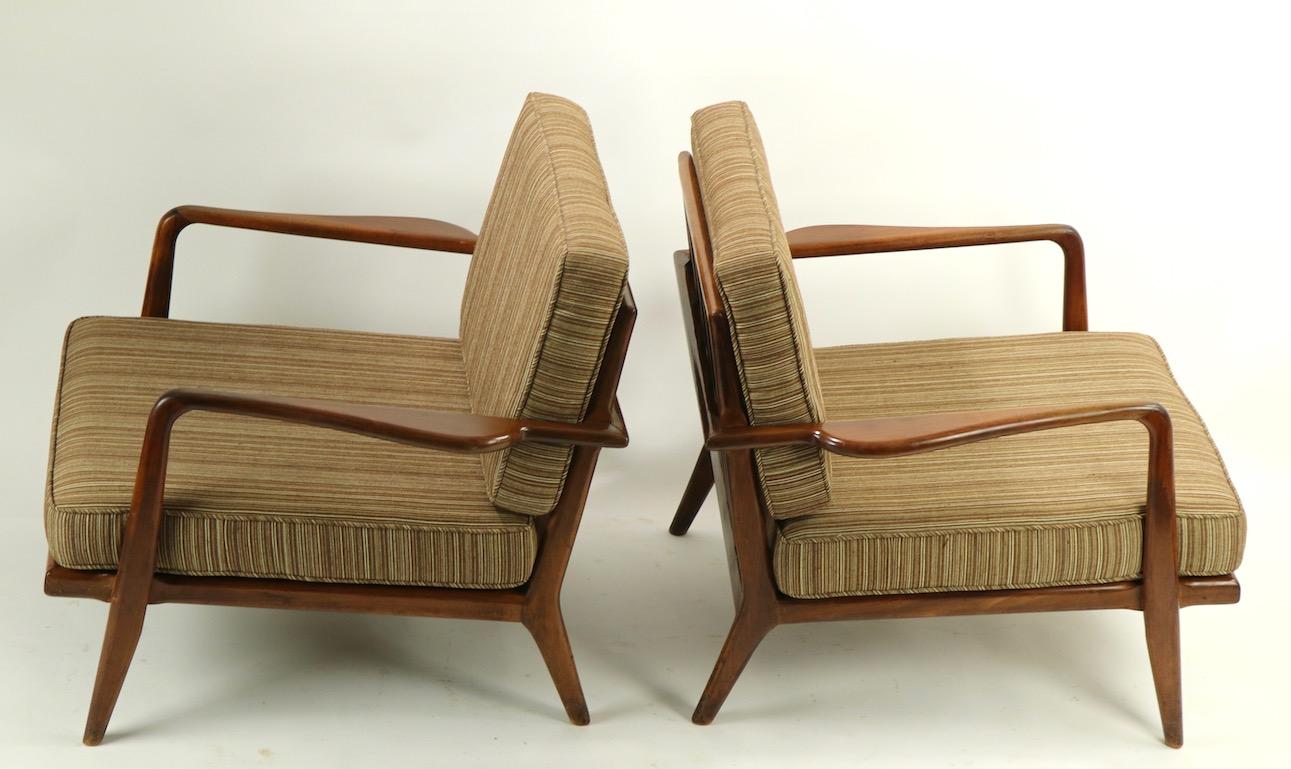 Classic low profile midcentury lounge chairs by recognized master of the period Mel Simlow. Both chairs are in original untouched condition, the frames show some cosmetic wear to finish, scuffs etc., pictured in listing. Measures: Total H 30 x arm H