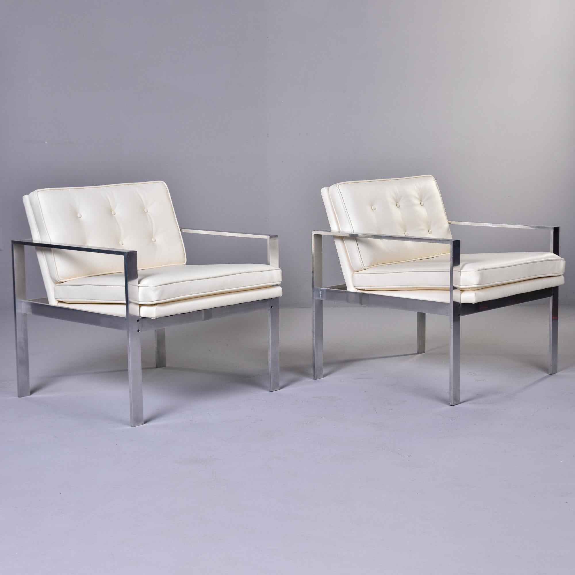 Found in the US, this pair of mid century aluminum frame chairs date from the late 1960s and are attributed to Harvey Probber. Newly upholstered in a creamy, off-white leather with flat bar style frames and a squared shape. Seat backs have button