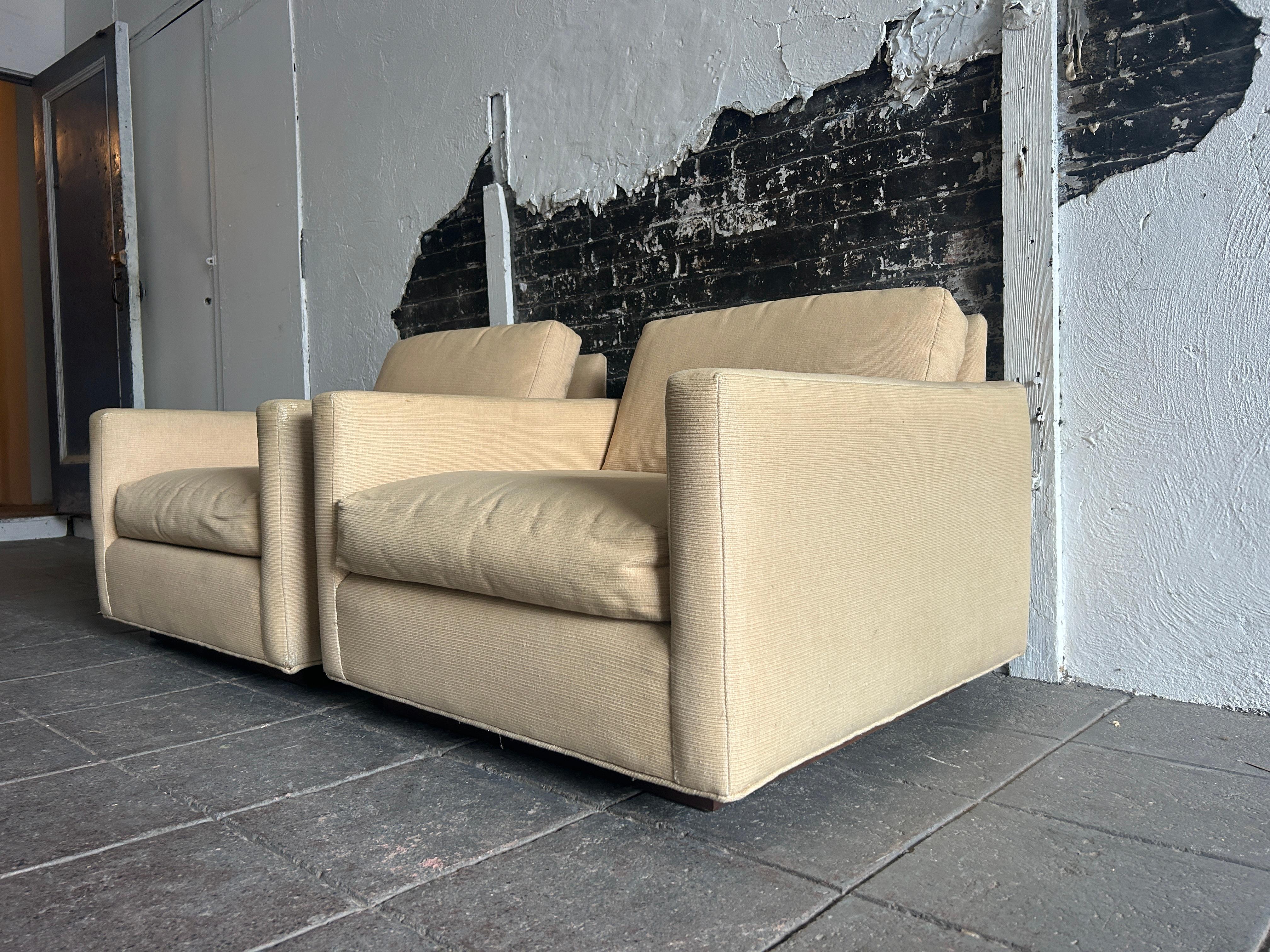 Pair Mid Century low tan lounge club cube chairs walnut base. Great set of low cube chairs in sand tan thick woven cotton upholstery. Floating square base in walnut. In the style of Milo Baughman. Made in USA located in Brooklyn NYC.

Sold as a pair