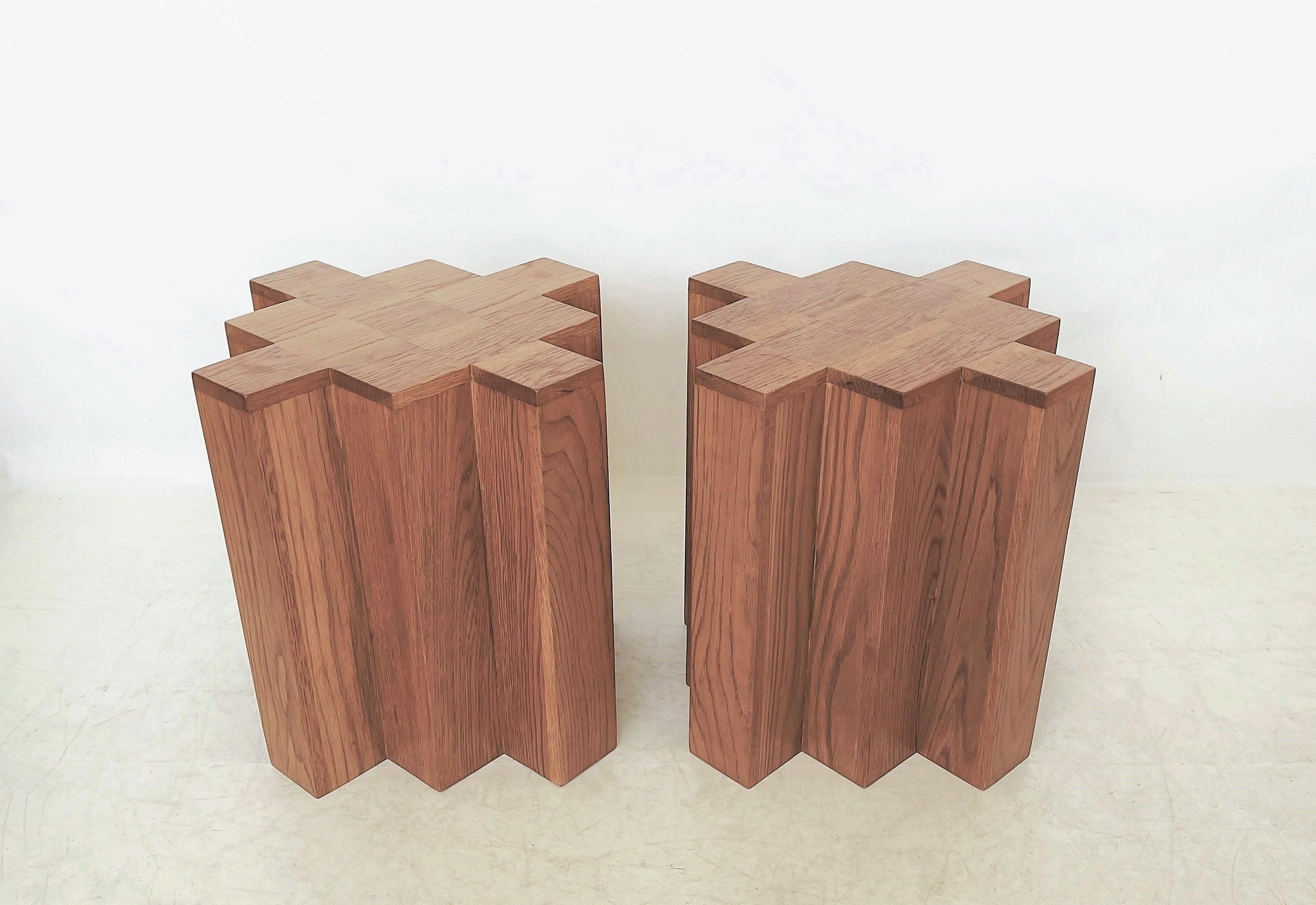 Pair of modern sculptural side tables. The strong geometric cube shaped with repetitive symmetrical setback corners is accentuated by the distinctive and recurring grain of natural oak wood. Great proportions. Incredible patina. It will natural