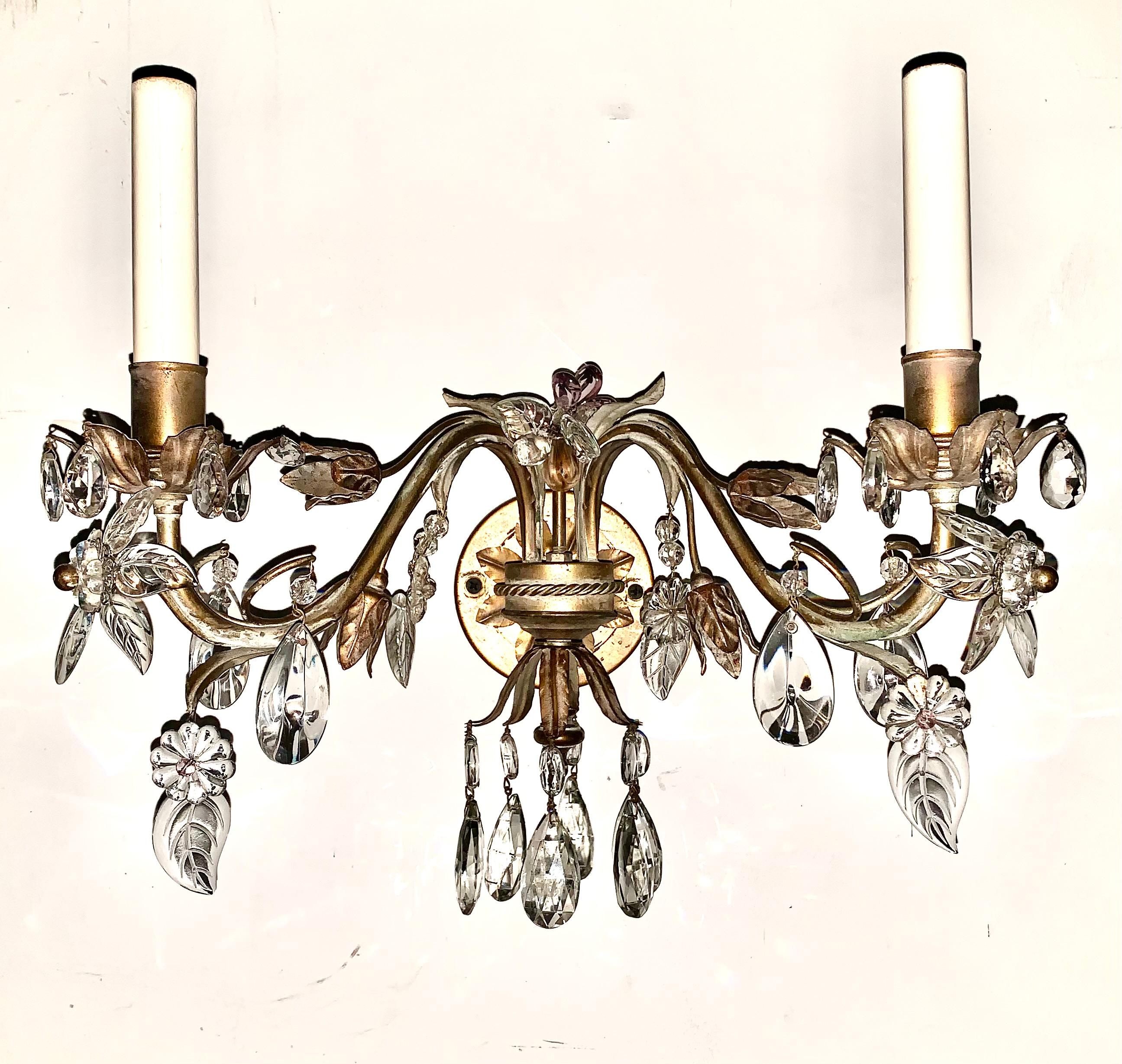 Pair French Maison Bagues style flower and leaf motif amethyst glass and crystal gilt metal two light sconces
20th Century
High quality, beautifully detailed French sconces composed of scrolled foliate and floral elements.
Wired for