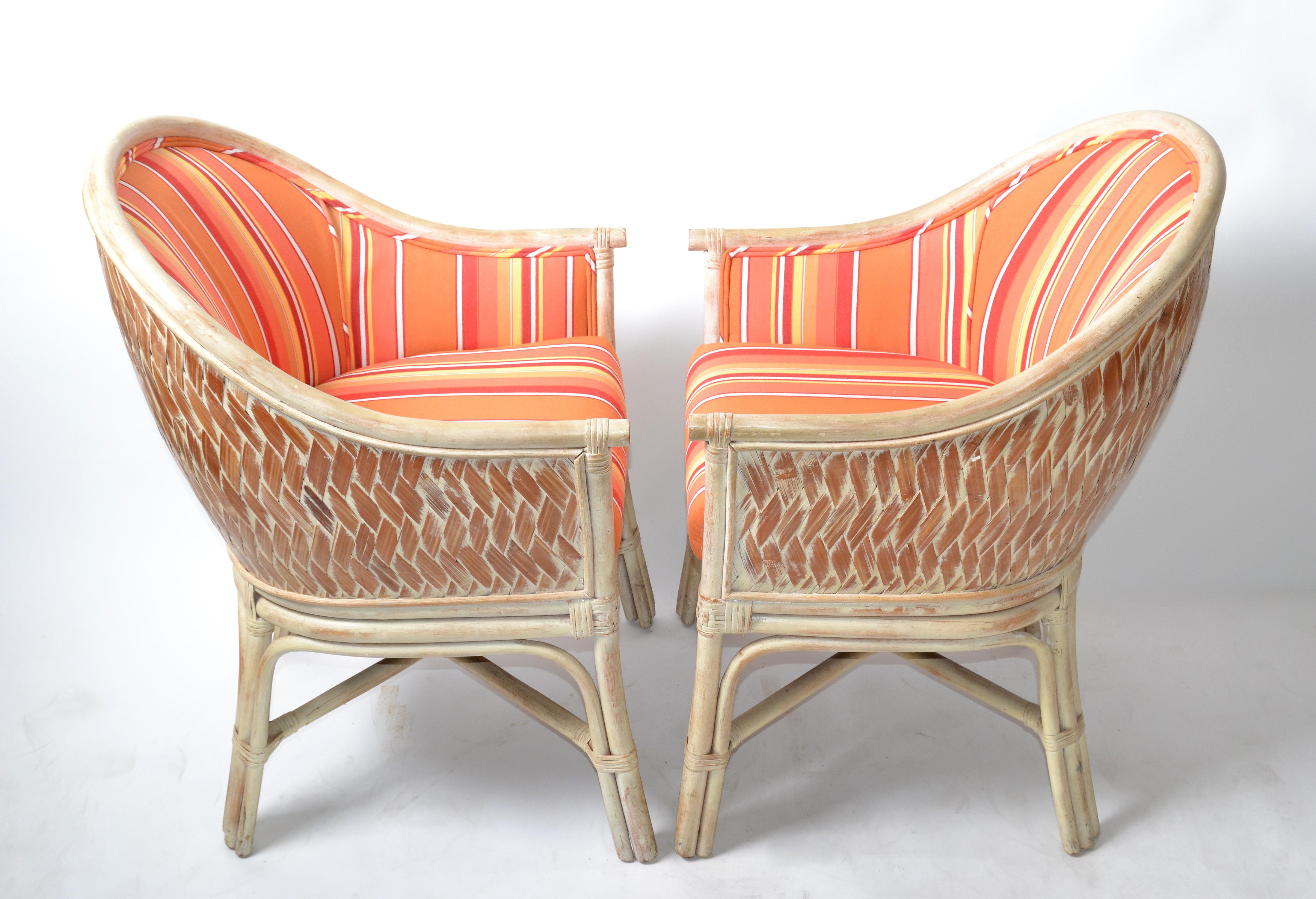 Pair of Bohemian style white washed bamboo and handwoven cane armchairs, with decorative X- base.
Vibrant orange striped cotton fabric Upholstery and each chair has a comfortable seat cushions.
Measures: Arm height 24.5 inches.