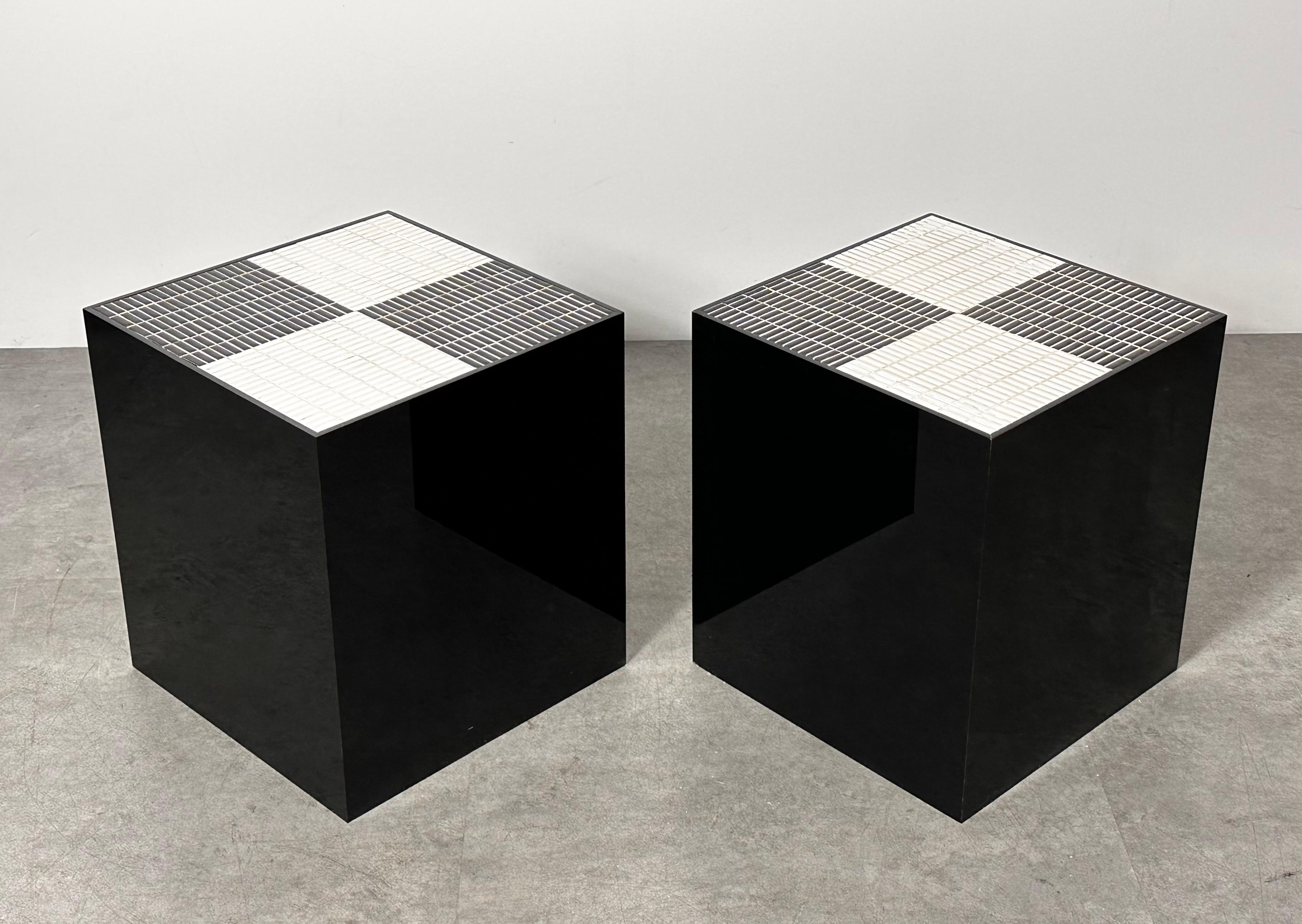 One of a kind of artist made mosaic tile top cube pedestal tables circa 1970s

Black acrylic squared bases with inset black and white checker pattern tile surfaces
Made by and from the estate of Detroit artist Deanna Bardy

Both sculptural and