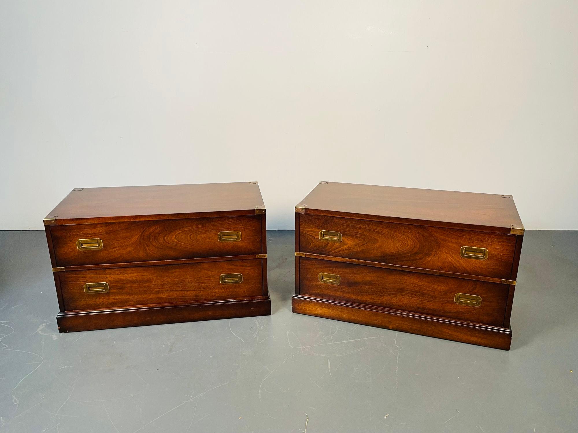 Pair of campaign low chests / nightstands, Baker Furniture Company
Flame mahogany Mid-Century Modern chests or bedside tables in the Campaign Fashion. Each having two drawers with sunken brass handles and brass carry handles on the sides. The pair