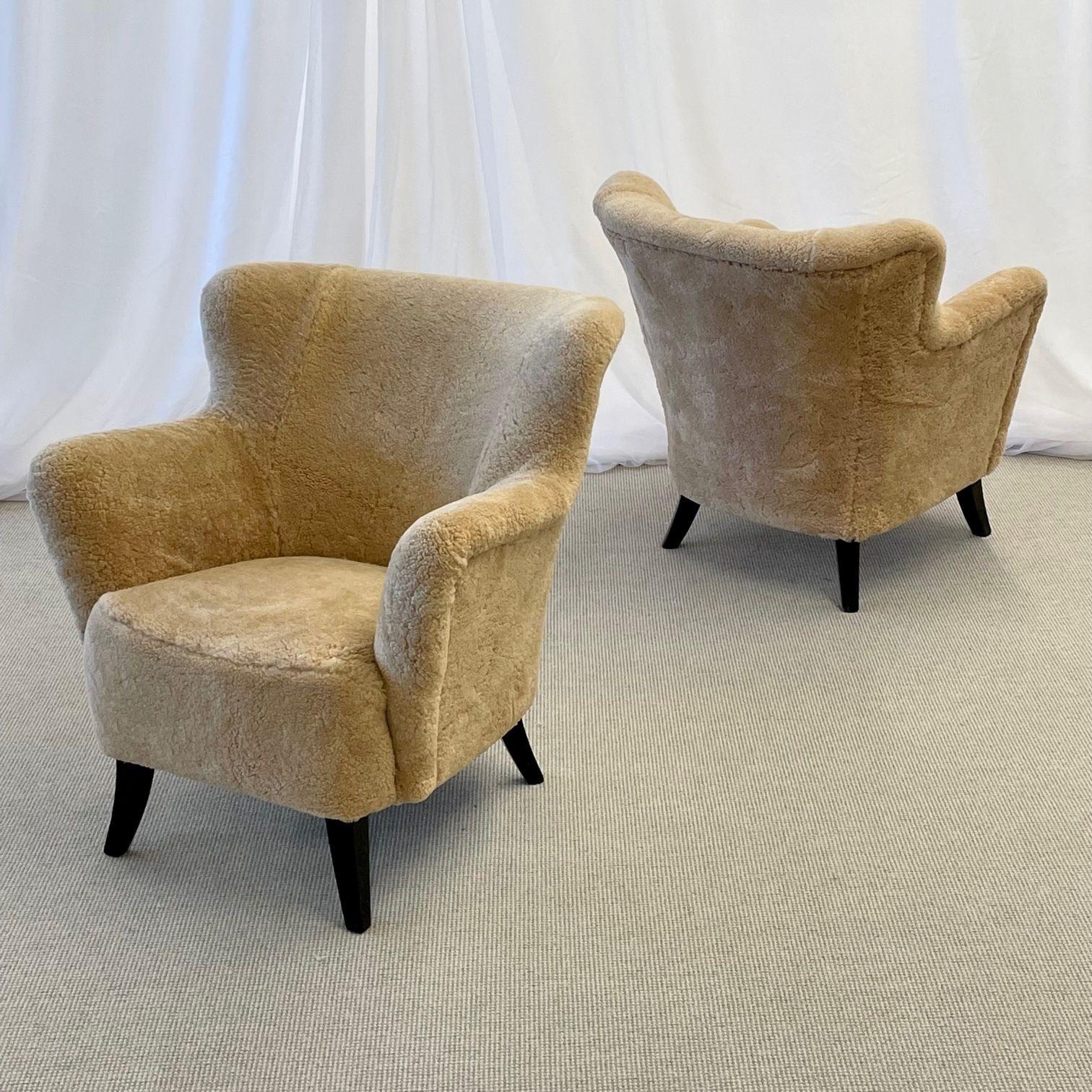 Danish Mid-Century Modern, Shearling Lounge Chairs, Sheepskin, Ebonized Wood, 1950s

Pair of organic form lounge chairs designed and produced in Denmark circa 1950s. The uppers feature freeflowing curves and organic form. Each chair sits on four