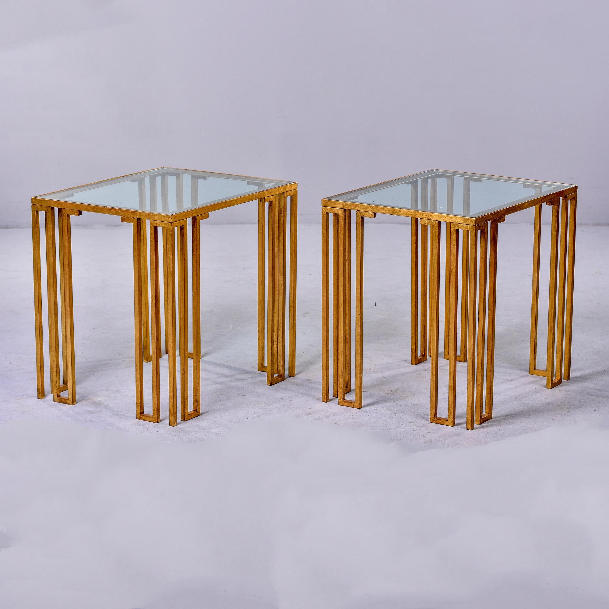 Found in France, this pair of circa 1980 side tables have gilt iron bases with open work legs and clear glass tops. Unknown maker. Sold and priced as a pair. 

Very good vintage condition with minor scattered surface wear to glass and bases. 