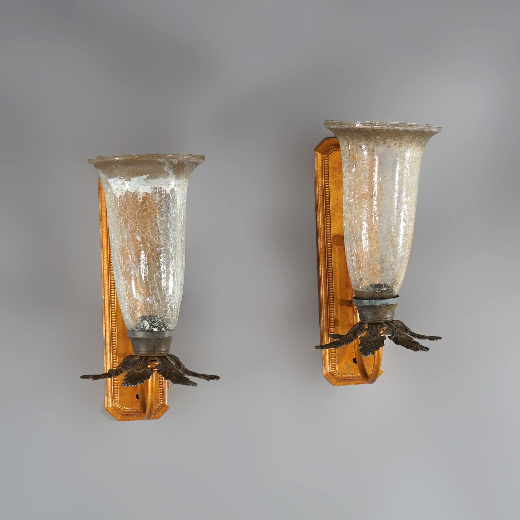 A pair of Mid-Century Modern French style Fleur-de-lis wall sconces with crackled glass shades, 20th century

Measures - 19