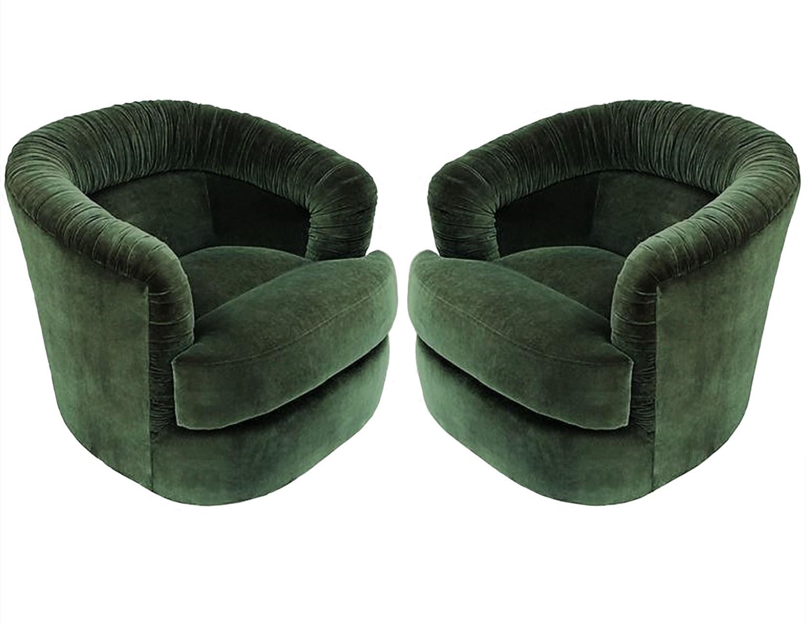 Fabulously unique pair of Mid-Century Modern Milo Baughman style swivel club chairs. These attractive chairs represent the perfect mix of design, function, and comfort. Luxuriously upholstered in soft green colored velvet, these wide and