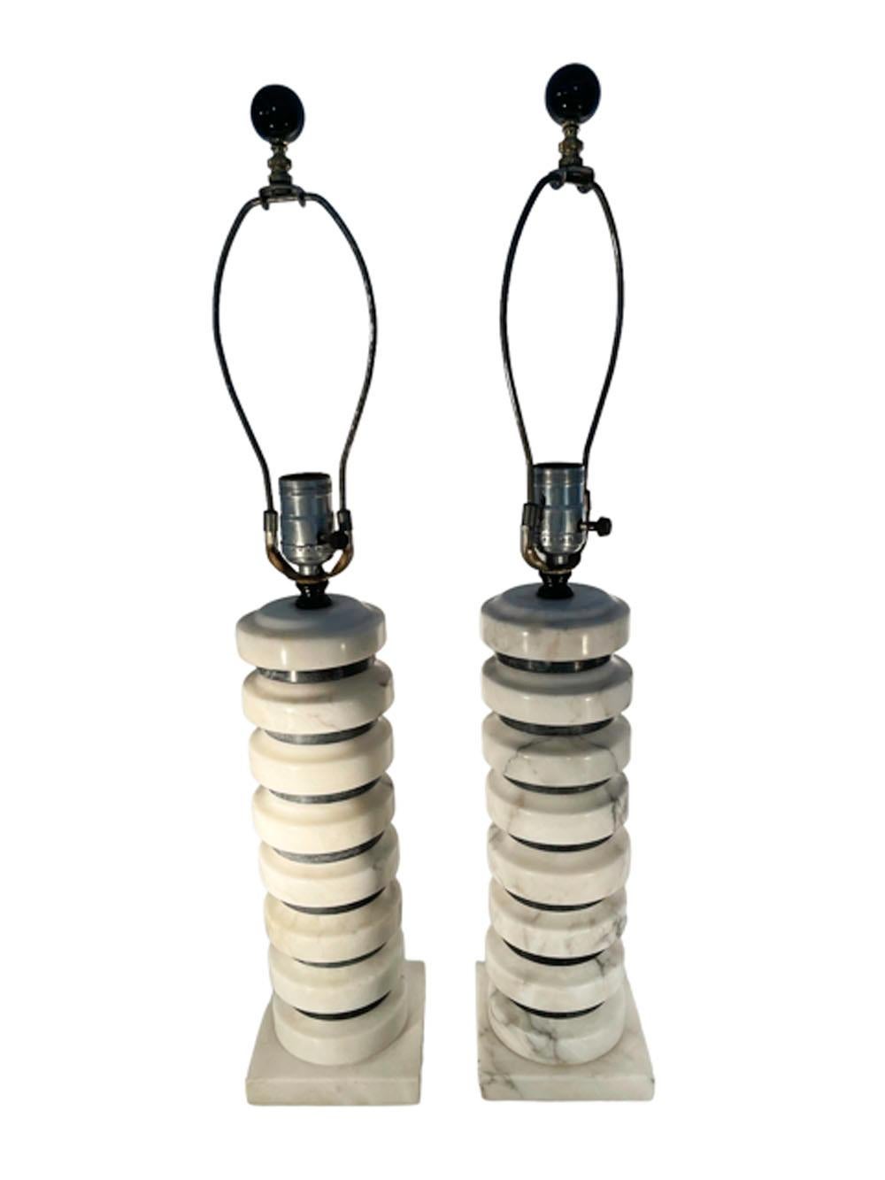 Pair of Mid-20th Century Italian alabaster table lamps of alternating gray and white disks on a square base. The smaller gray disks have a flat profile while the white disks have a shaped top edge. Newly re-wired.
Measures: Base: 4.5