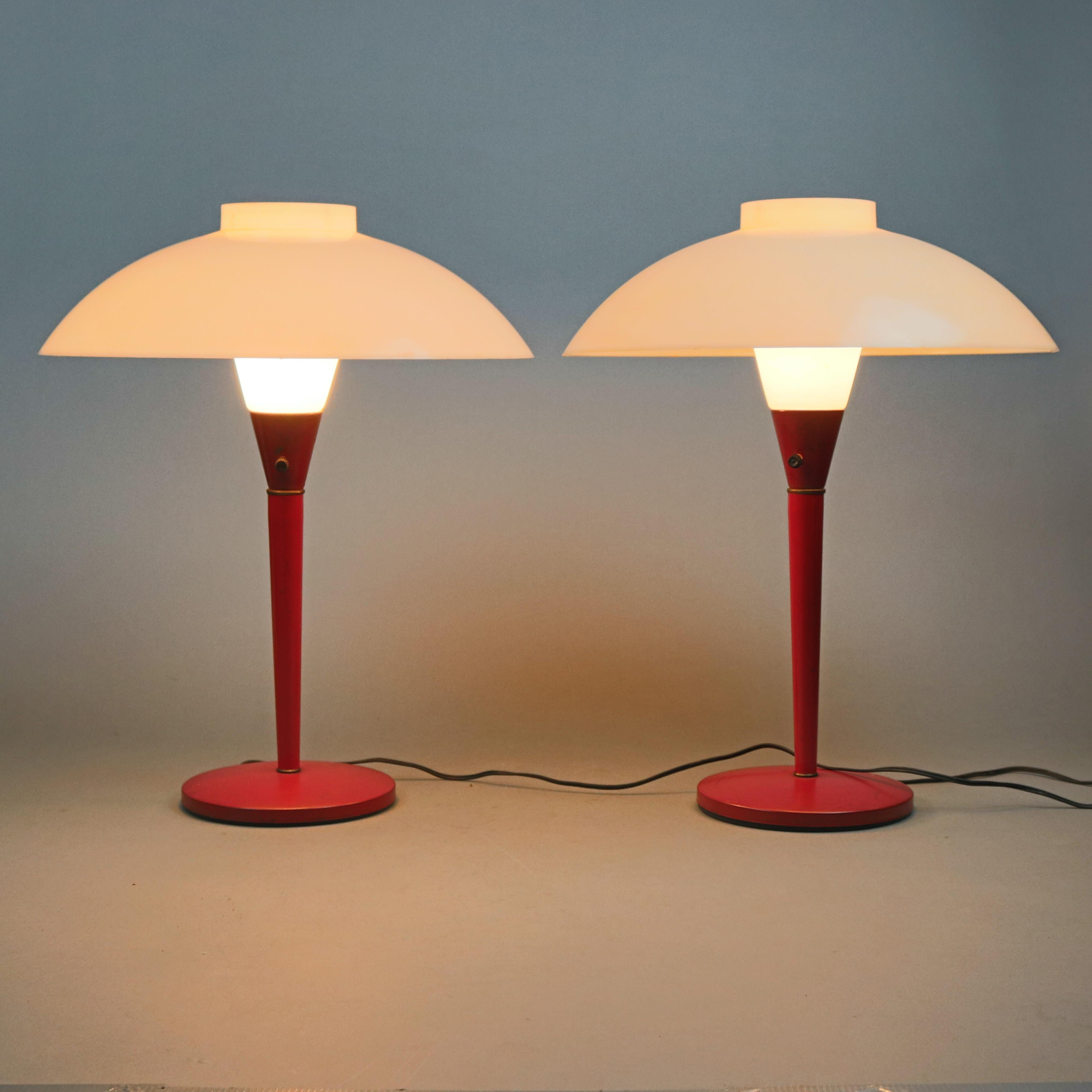 A pair of Italian Mid-Century Modern umbrella portable table lamps offer mushroom form with painted metal base surmounted by umbrella dome form opaque acrylic shades, circa 1960

Measures - 20