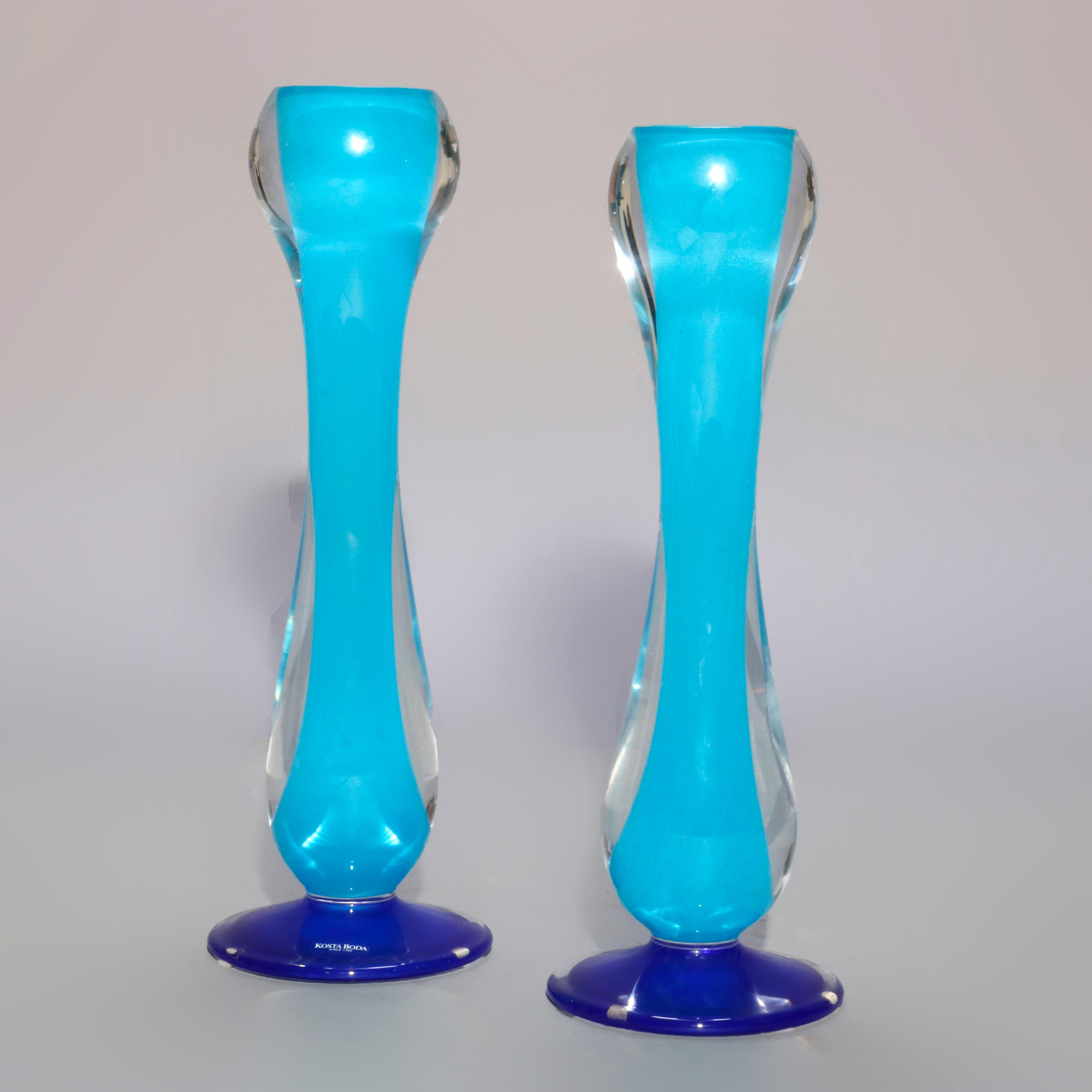A Mid-Century Modern pair of candlesticks by Kosta Boda offer silhouette form in blue and colorless art glass, maker mark as photographed, circa 1960

Measures: 1) 12.5