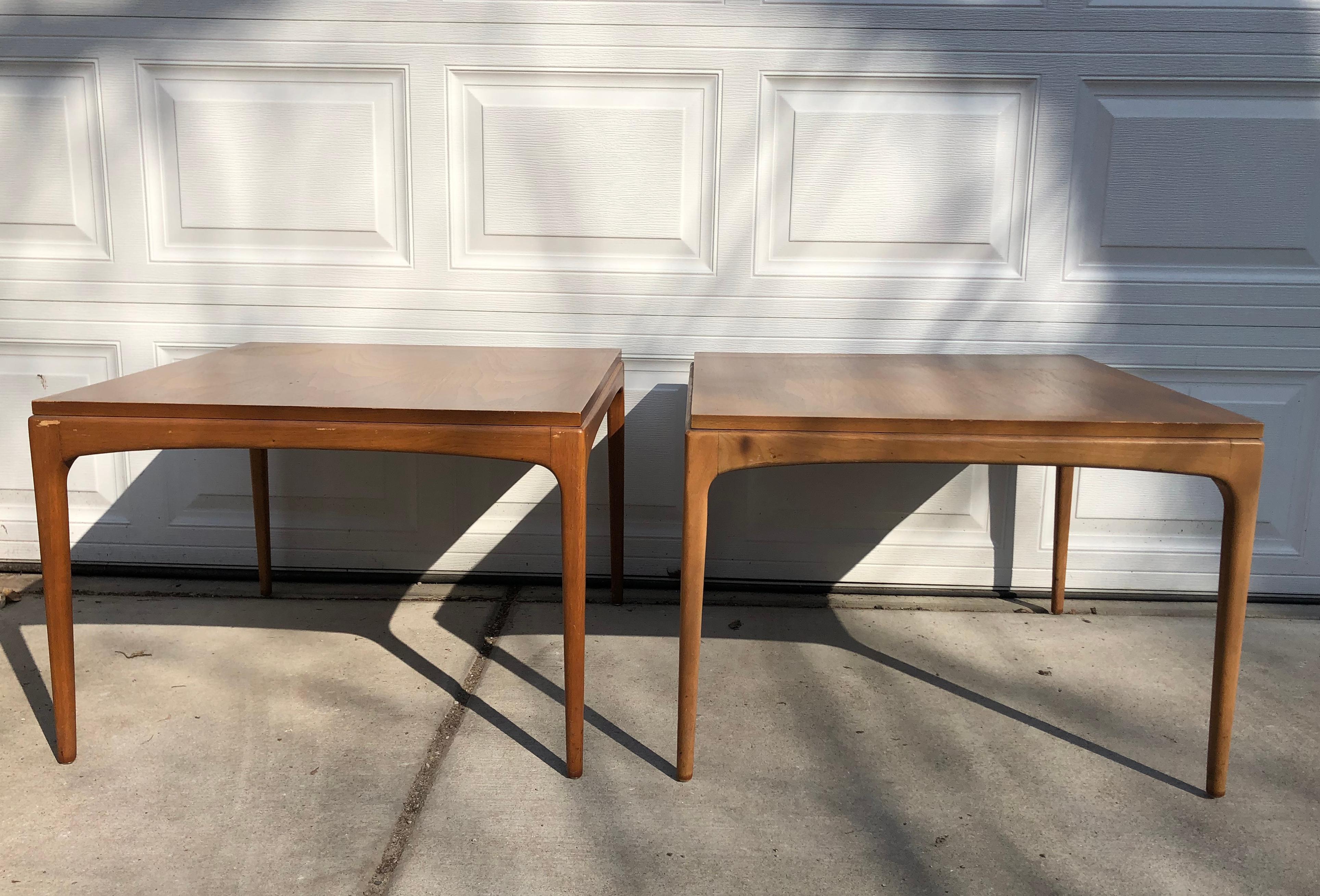 Pair of original condition (not refinished) American walnut side tables by Lane. This Mid-Century Modern coffee table in walnut was made in Altavista, Virginia, from the early 1960s. The top has an inlaid border resting on circular tapering