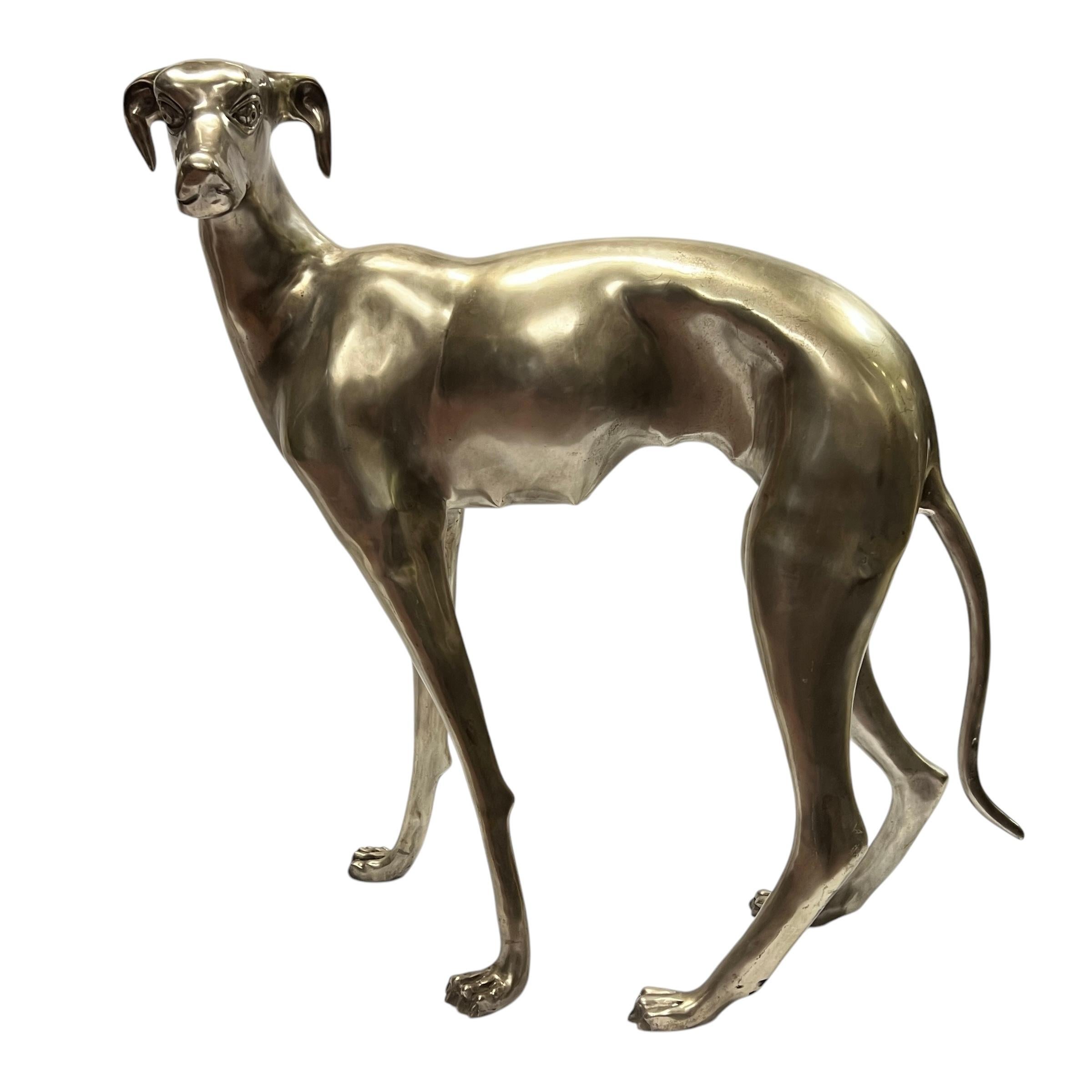 Pair of vintage mid-century modern lifesize sculptures of standing greyhound dogs finely cast in bronze with silver patina.  Each approximately 31 by 30 by 9 inches.