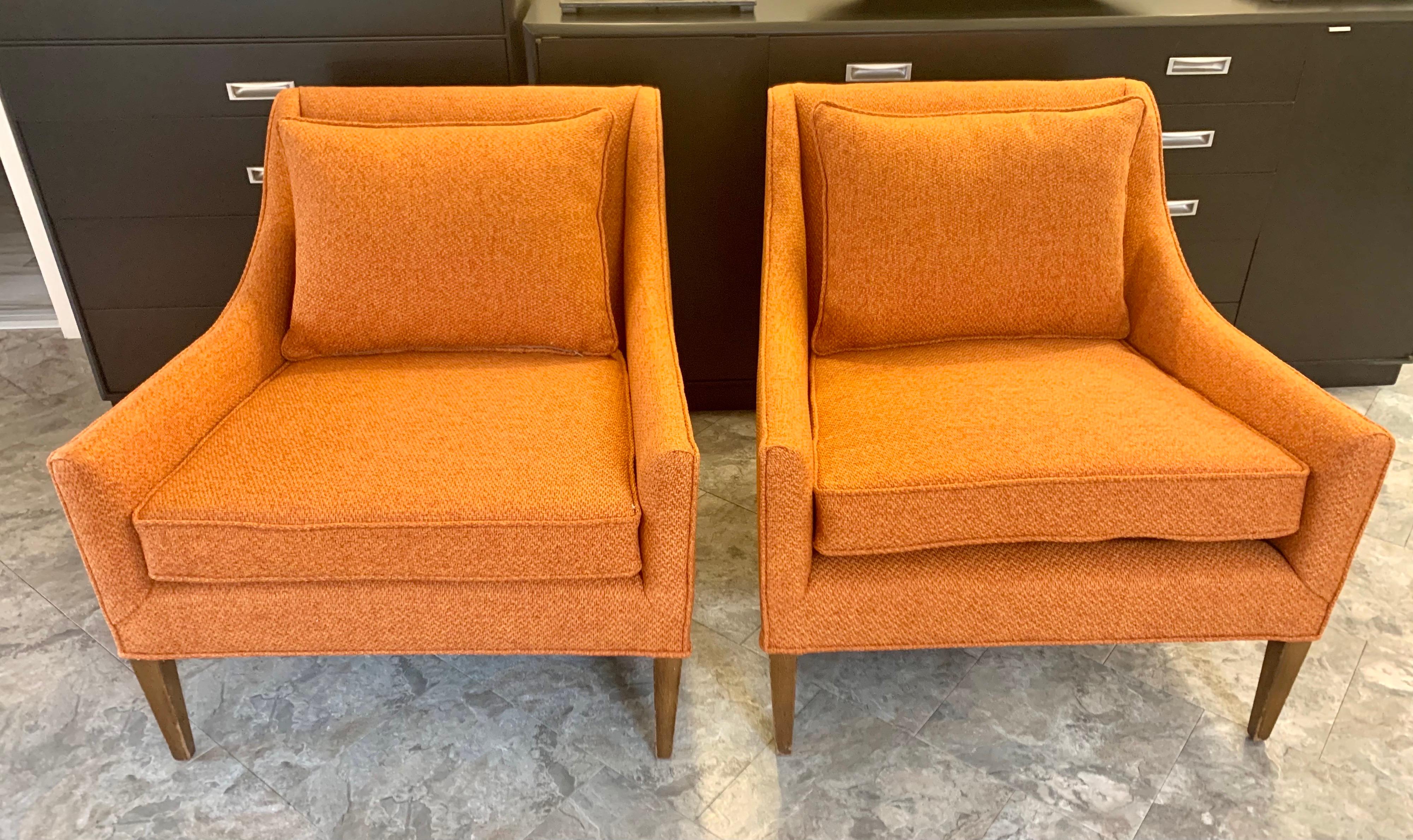 Just reupholstered in a gorgeous Hermes orange colored woven fabric, this pair of Mid-Century Modern arm chairs. Great condition. All dimensions are below.