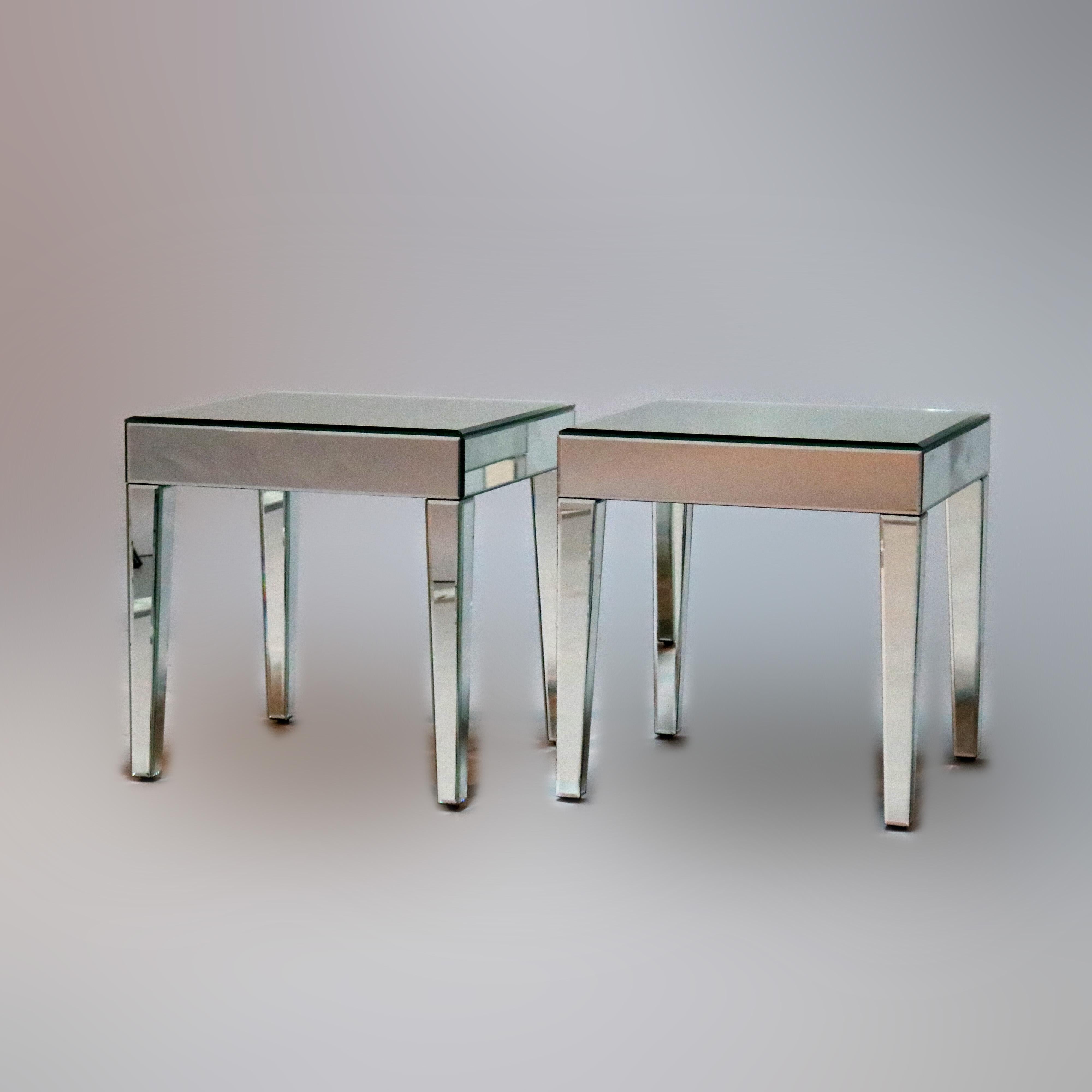 A pair of Mid-Century Modern side tables offer mirrored construction raised on tapered straight legs, circa 1960

Measures: 19.25