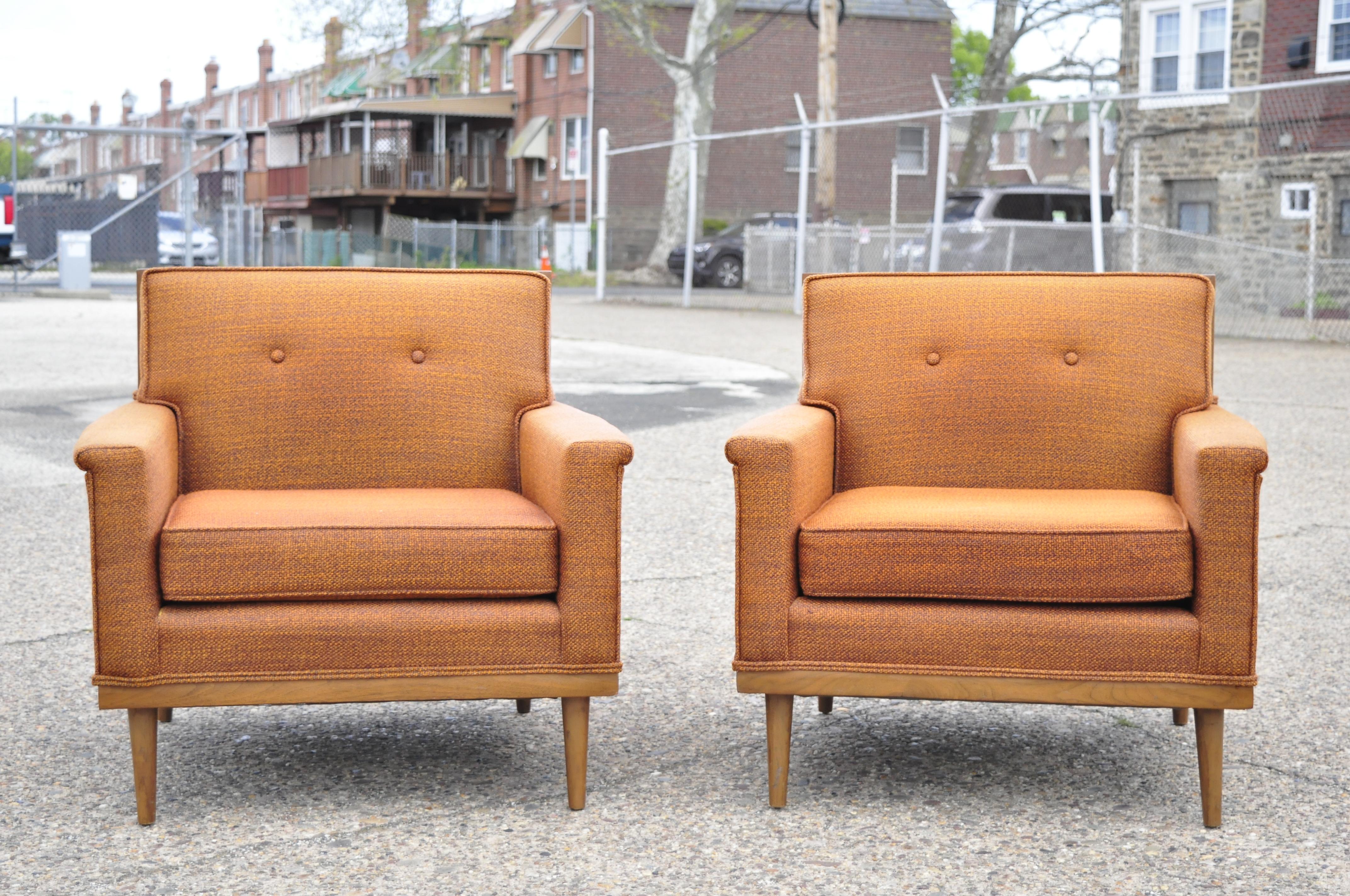Pair of Mid-Century Modern Paul McCobb style club lounge chairs by J.B. Sciver. Item features a solid wood trimmed frame, flared arms, solid wood frame, original label, tapered legs, clean modernist lines, sleek sculptural form, circa mid-20th