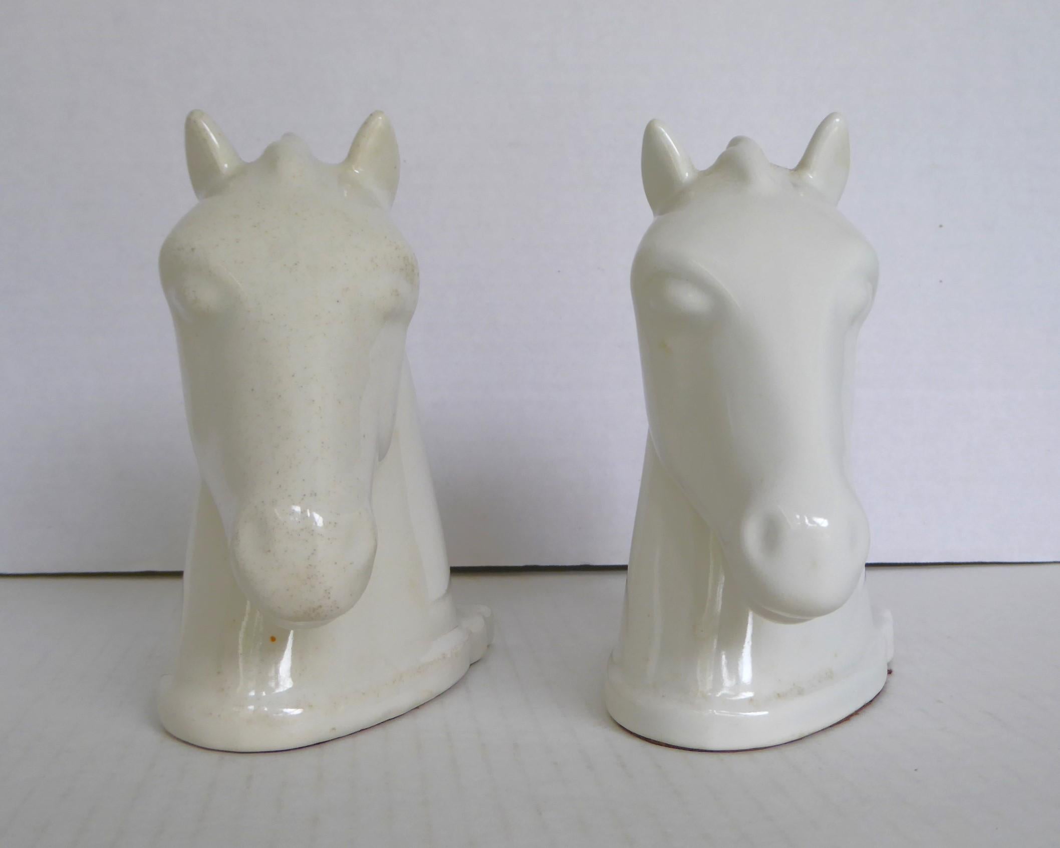 Handsome Pair of Mid Century white Horse Head Modern Bookends by Abingdon Potteries.   Beautiful designed horse heads bookends in glossy white glaze which were produced from 1938 through 1950. Due to the long production period, some of the glazes