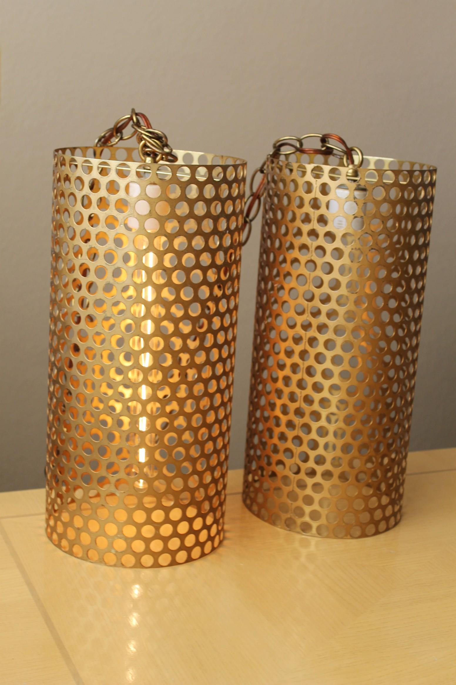 Magnificent!

Pair Italian Metal
Pendant/Swag Lamps
for Raymor

Attributed to Gino Sarfatti

These are the quintessential, mid century modern Italian swag lamps!  Beautiful in their simplicity and elegance, perforated metal acts as a screen for a