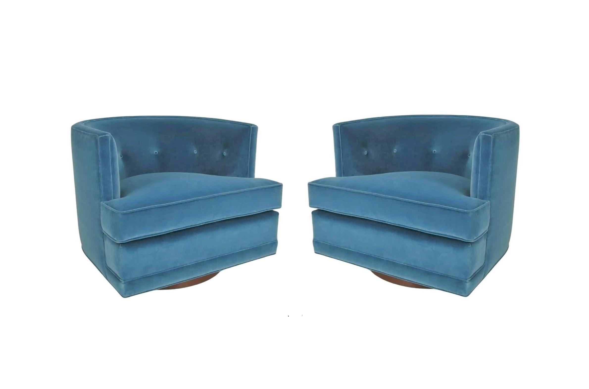 Retro glamour meets modern comfort pair of swivel lounge chairs attributed to Harvey Probber. Pristinely tailored chairs feature a barreled tufted back creating a cozy embrace, oversized detached plush cushion seat and flat front aprons, freshly