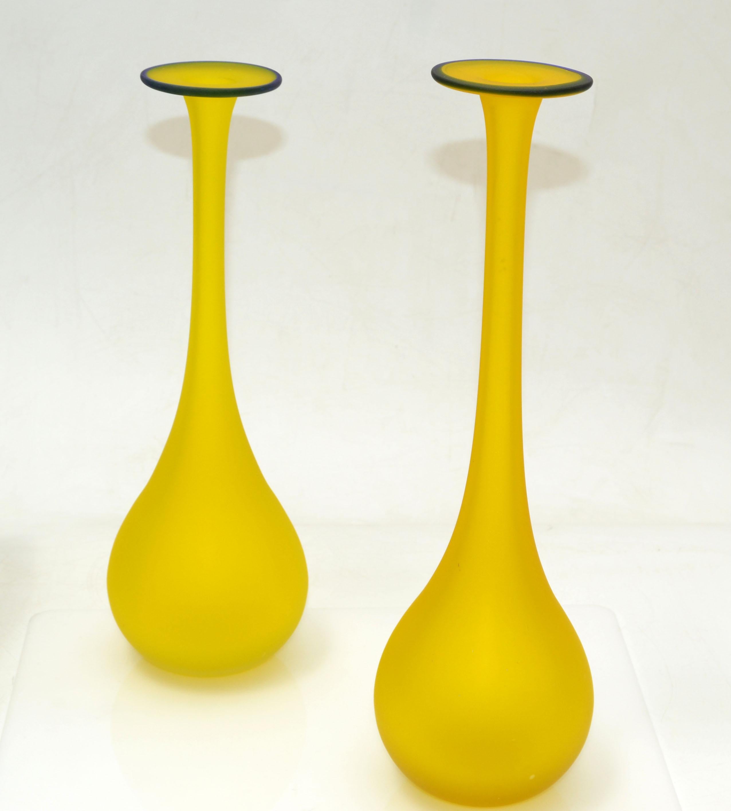 Pair of Carlo Moretti style Mid-Century Modern satin glass bud vase in translucent yellow with a blue opening.
Nesting set, the smaller one is one inch smaller, 11.5 inches.
Very beautiful and clean design.

