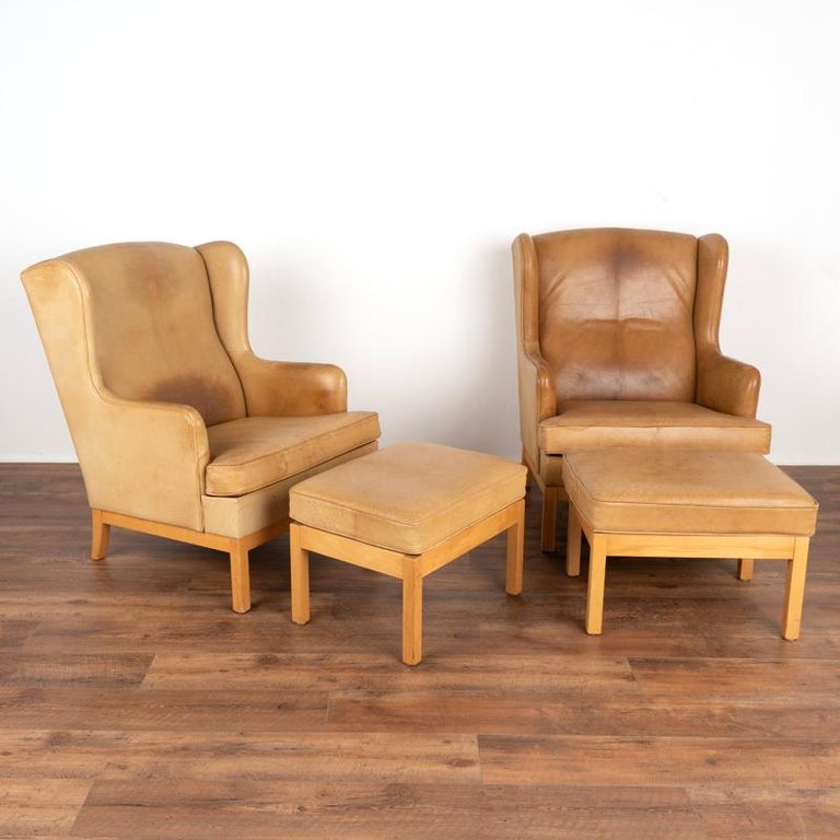 For those who love a great vintage find, to acquire a pair is even more special. This set of two wingback leather chairs and matching ottomans is just that. They show off their mid-century style in the sleek, clean lines and beech frames. The heavy