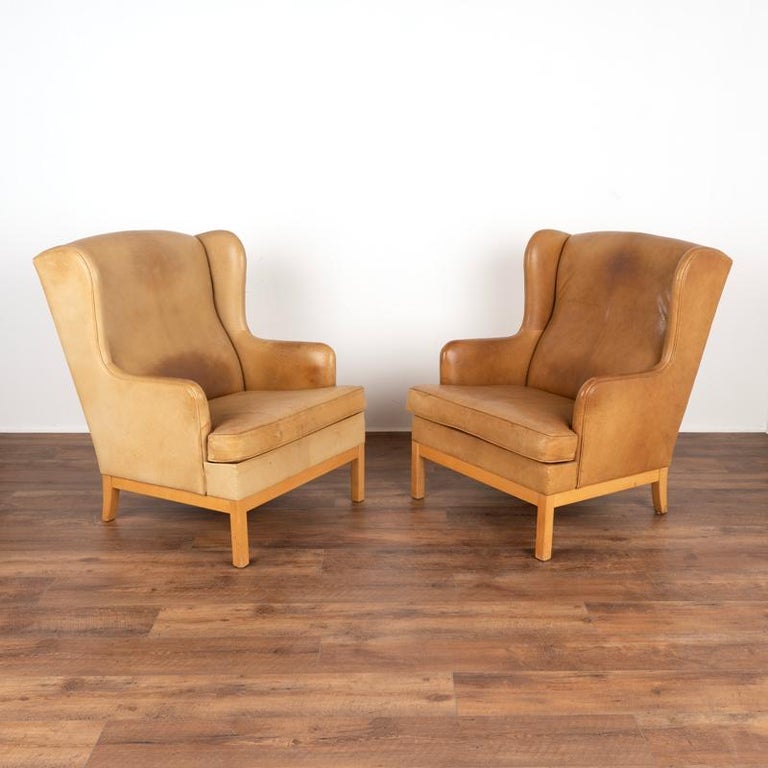 Mid-Century Modern Pair, Mid Century Modern Vintage Tan Leather Wingback Armchairs and Matching Ott For Sale