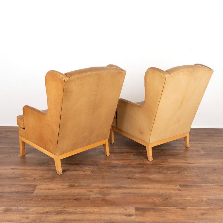 Pair, Mid Century Modern Vintage Tan Leather Wingback Armchairs and Matching Ott In Good Condition For Sale In Round Top, TX