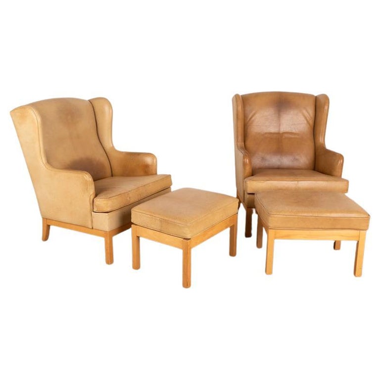 Pair, Mid Century Modern Vintage Tan Leather Wingback Armchairs and Matching Ott For Sale