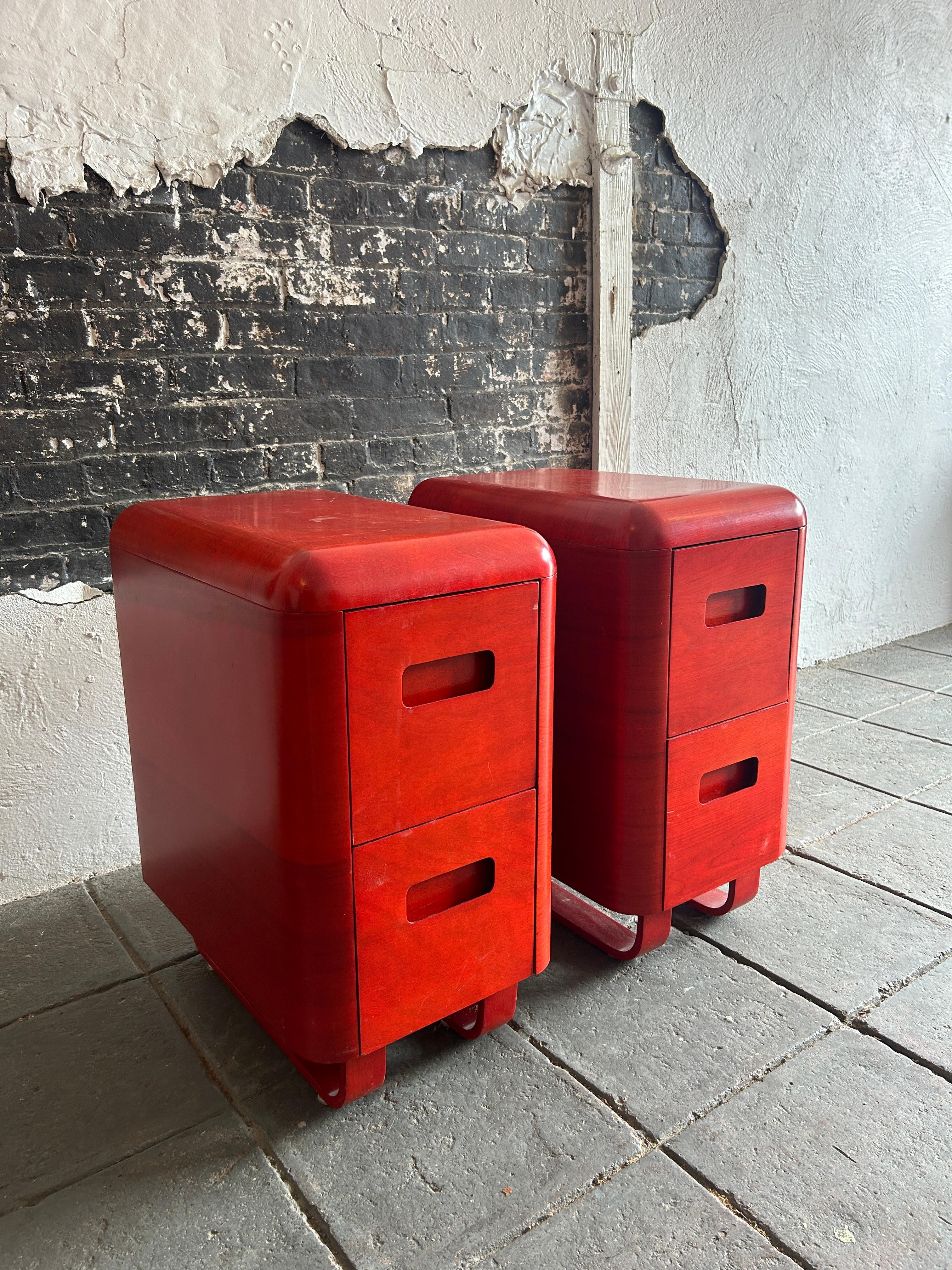 Rare Pair of Mid century molded plywood 2 drawer nightstands by Paul Goodman for plymold In red translucent Lacquer. Has rounded design with concave handles with bentwood curved drawers and legs. Good vintage condition. Located in Brooklyn