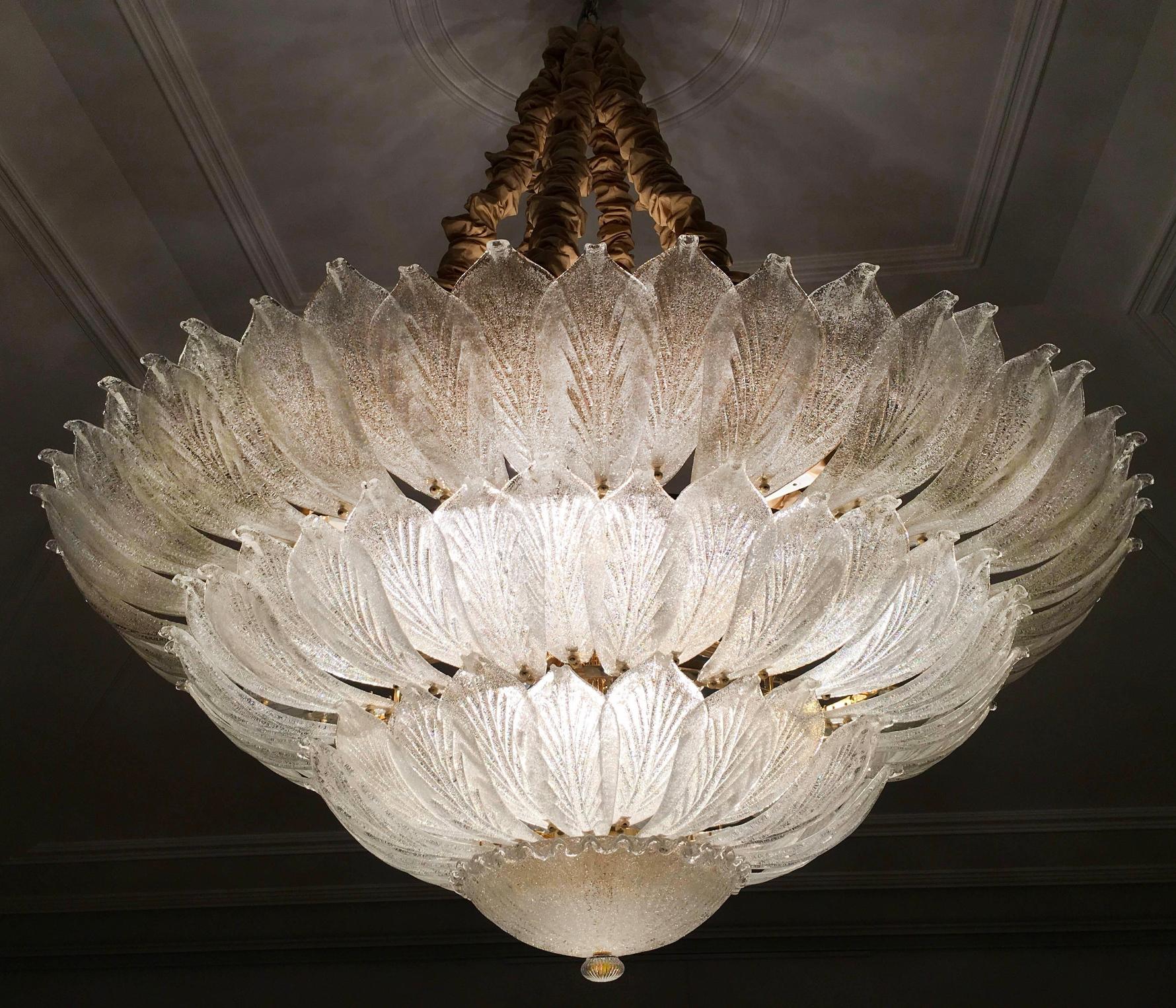 Realized in pure Murano glass consist of an incredible number of leaves. The structure is plated with gold 18 lights spread a magical light. Measures: Diameter 126 cm, height 65 cm and chain.