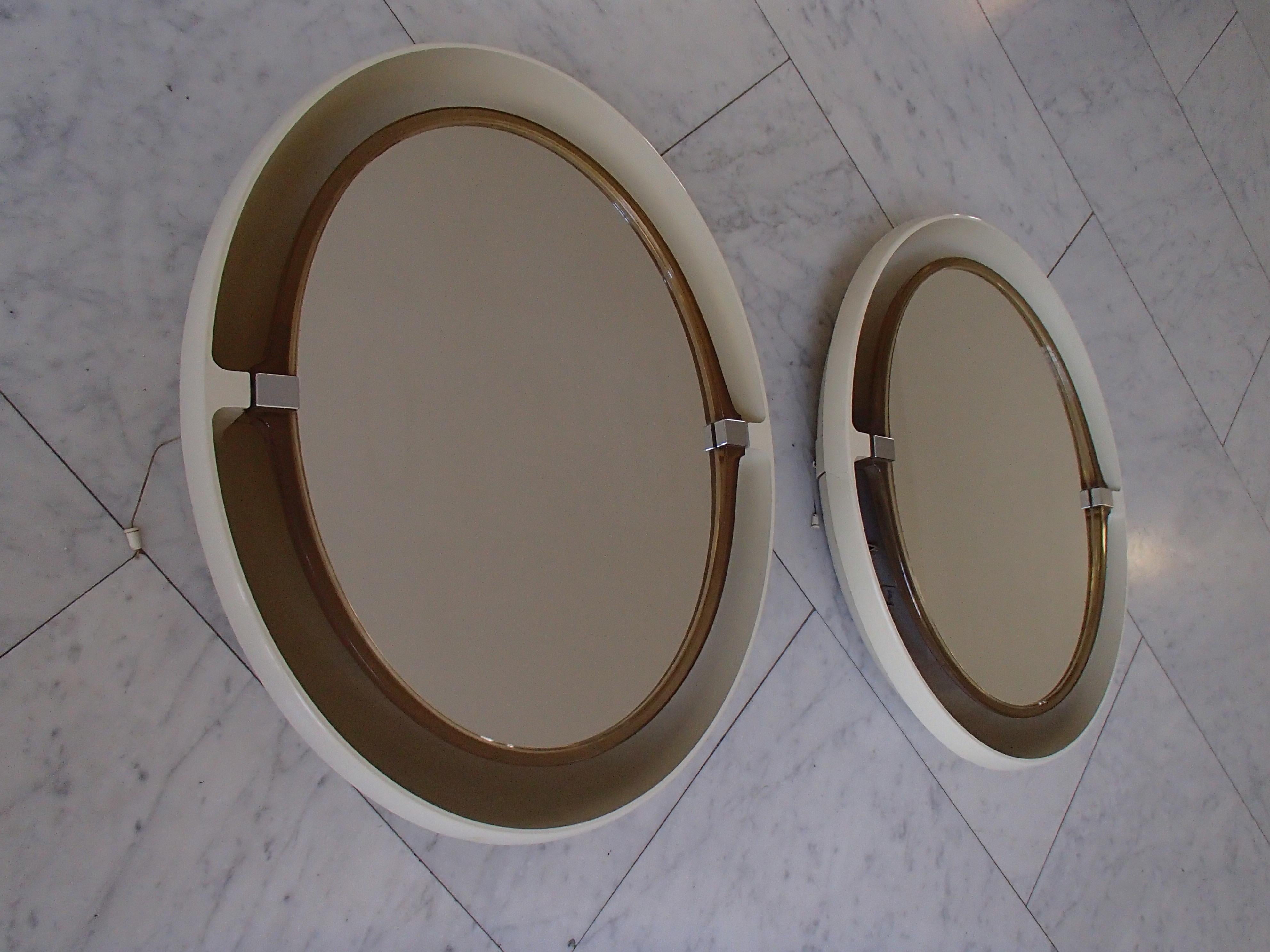 Pair of midcentury oval movable bathroom mirrors with 4 bulbs.